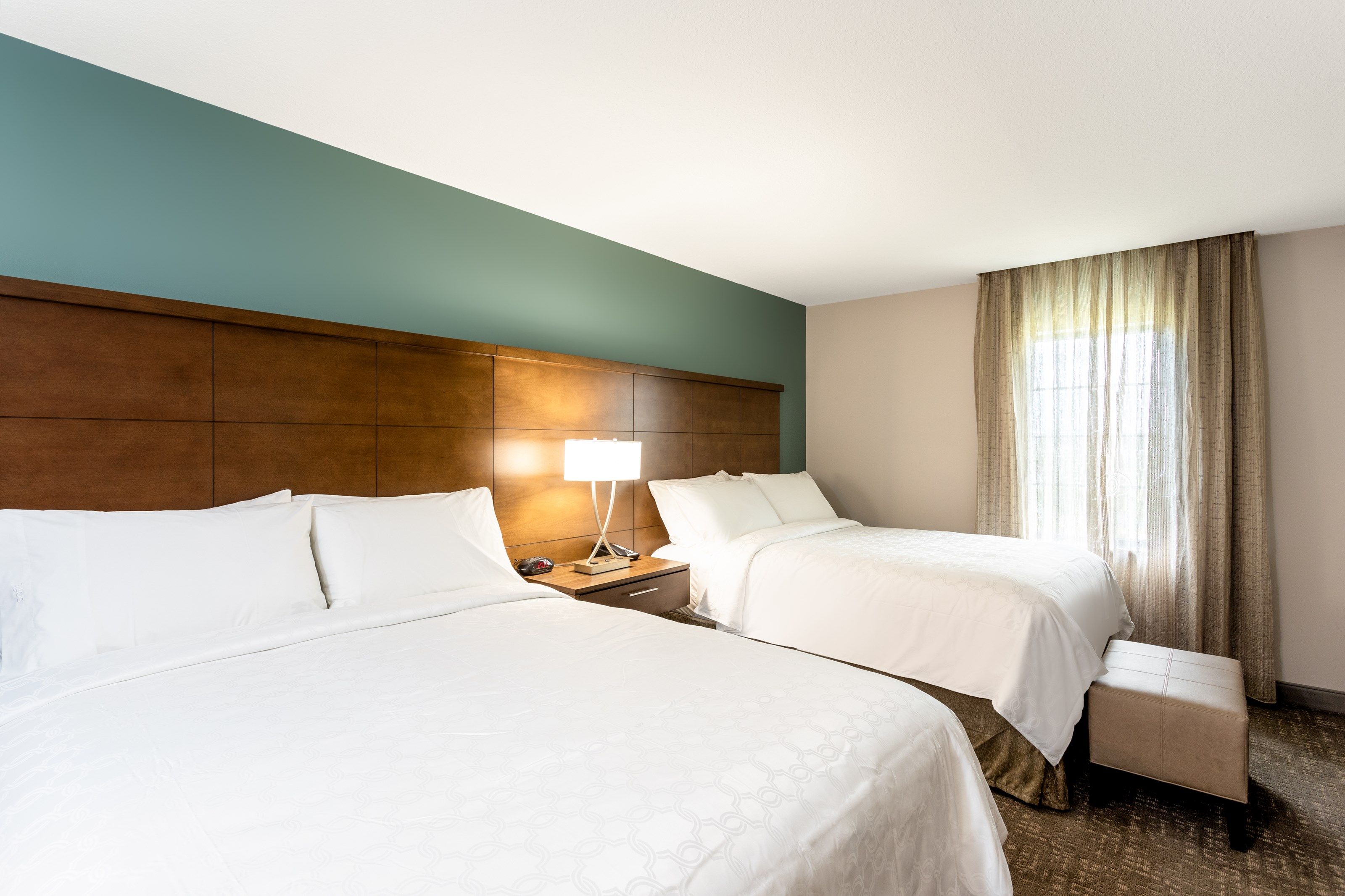 image Two double beds with white linens — plenty of room for the whole group
