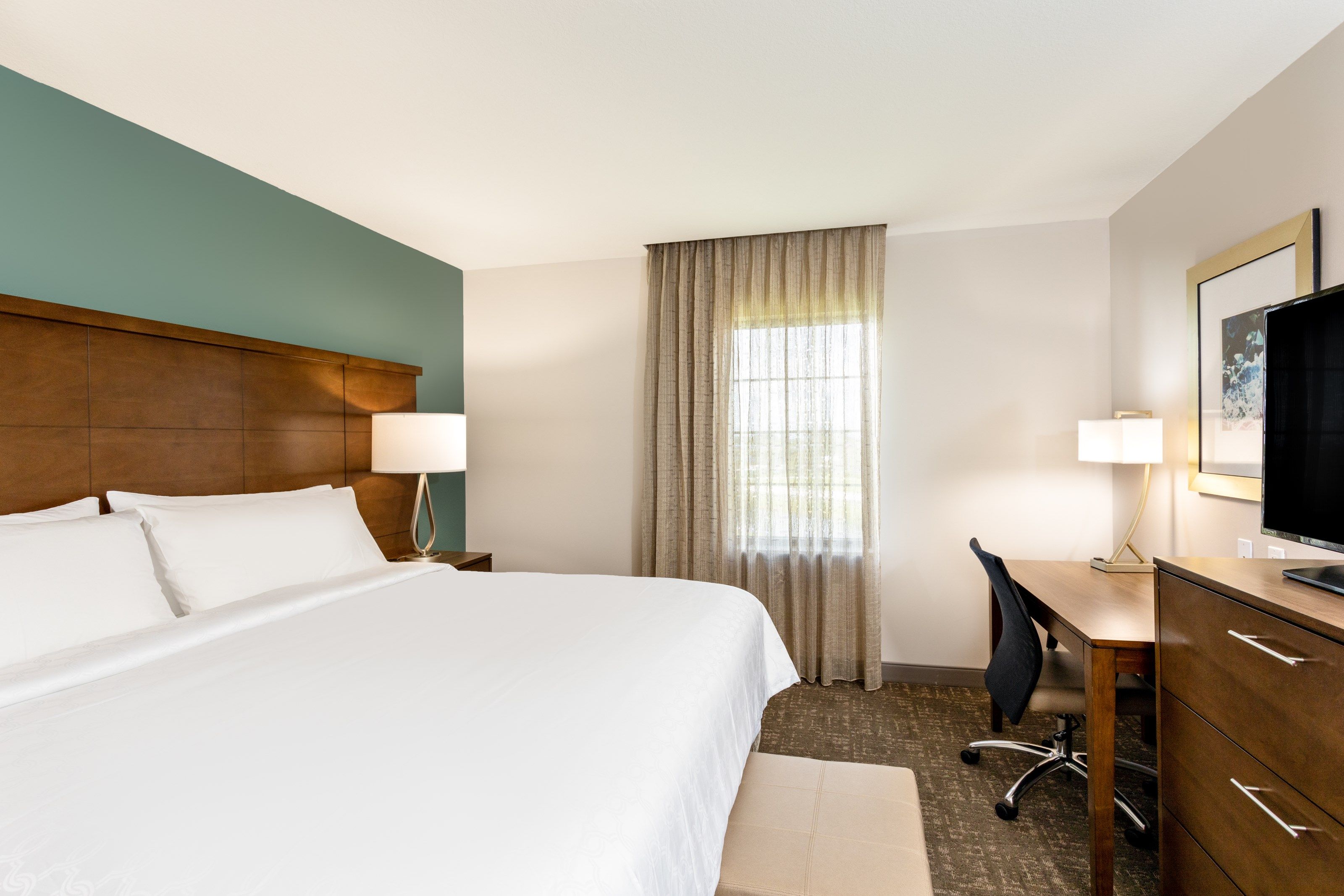 image Two separate bedrooms — each with a flat-screen TV, air conditioning, and ample storage