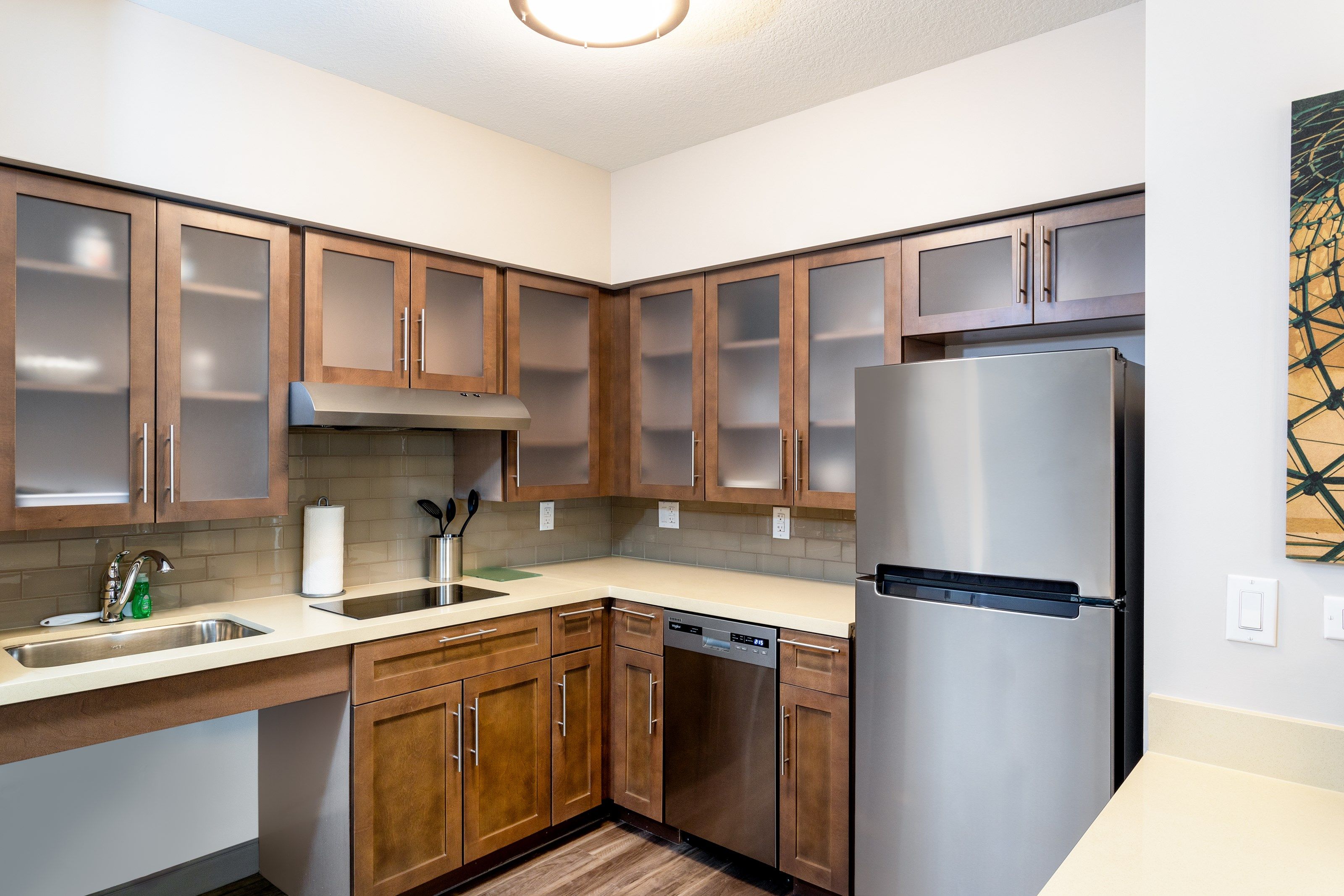 image Full kitchen with refrigerator, stovetop, microwave, and dishwasher — bar seating for two