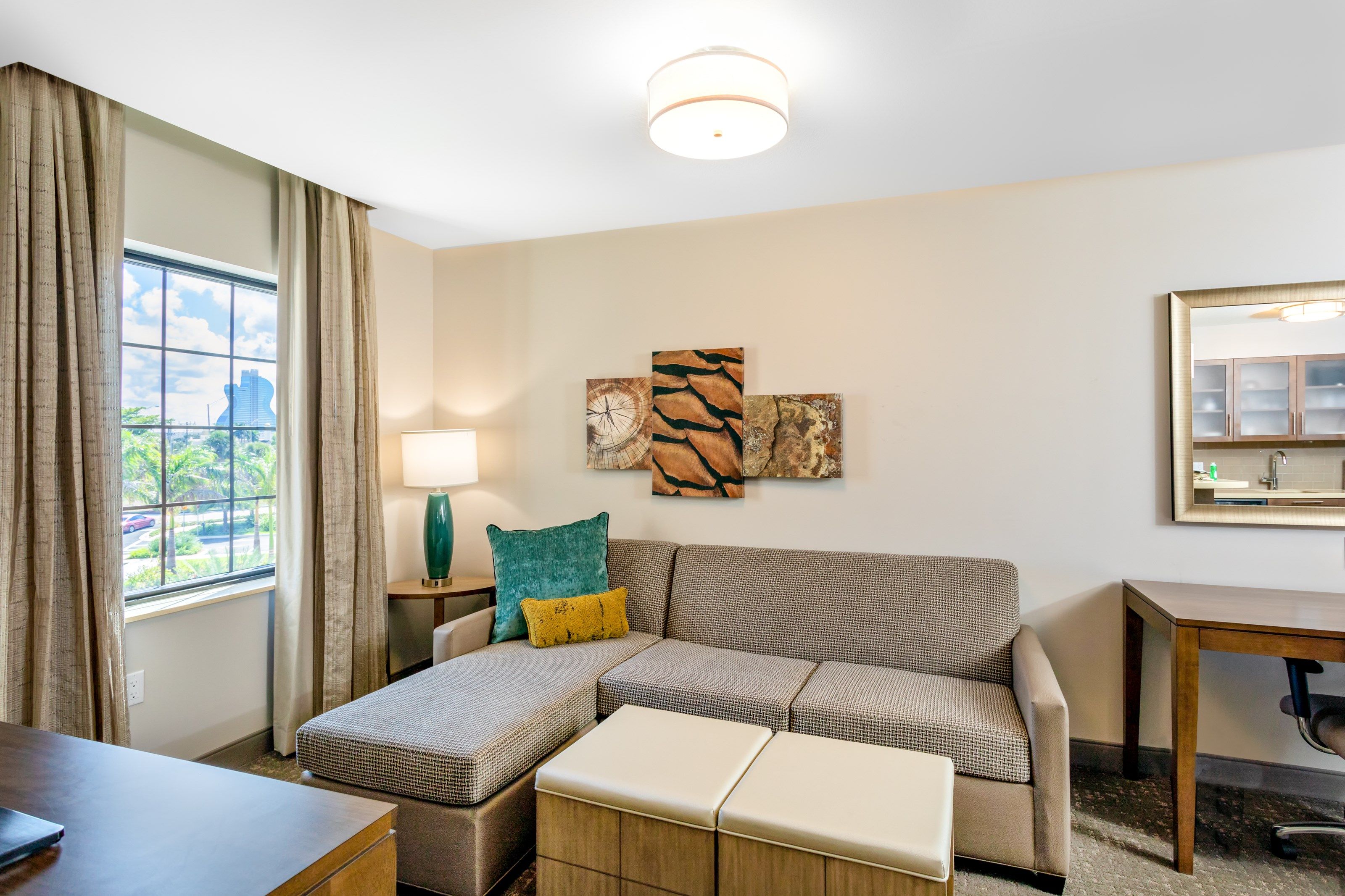 image Two-bedroom layout with a wide living area, flat-screen TV, and dedicated work desk