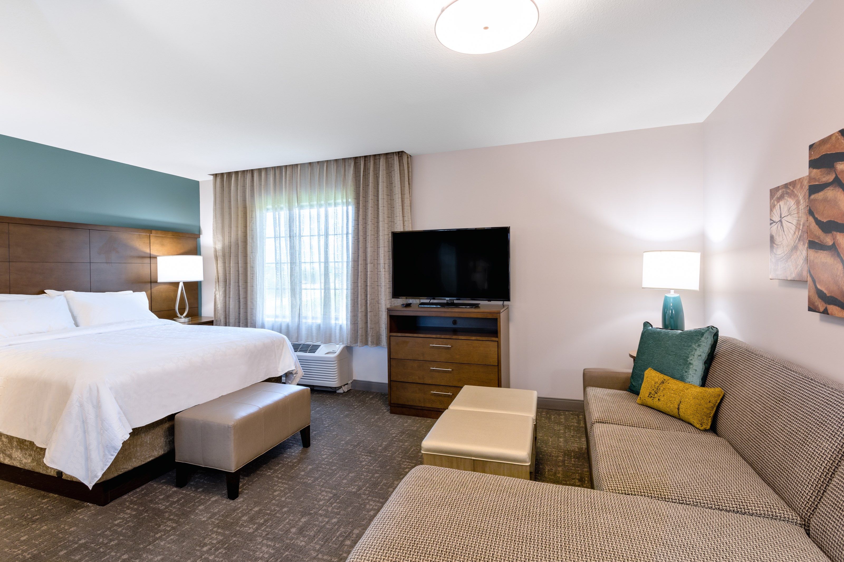 image Queen bed, sofa bed, and flat-screen TV in the bright studio — the work desk keeps you connected too