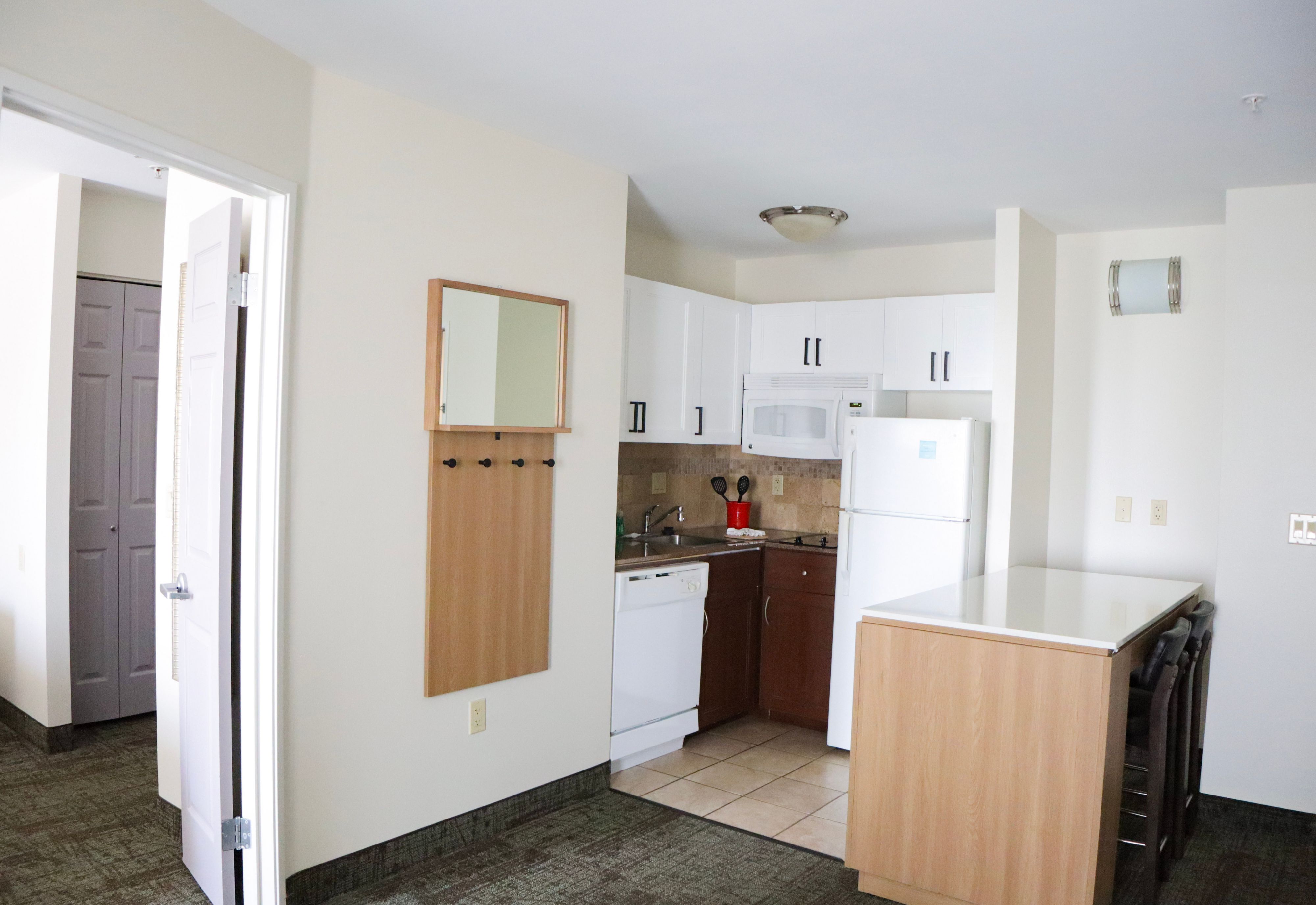 image Kitchen with dining counter, refrigerator, and stove.