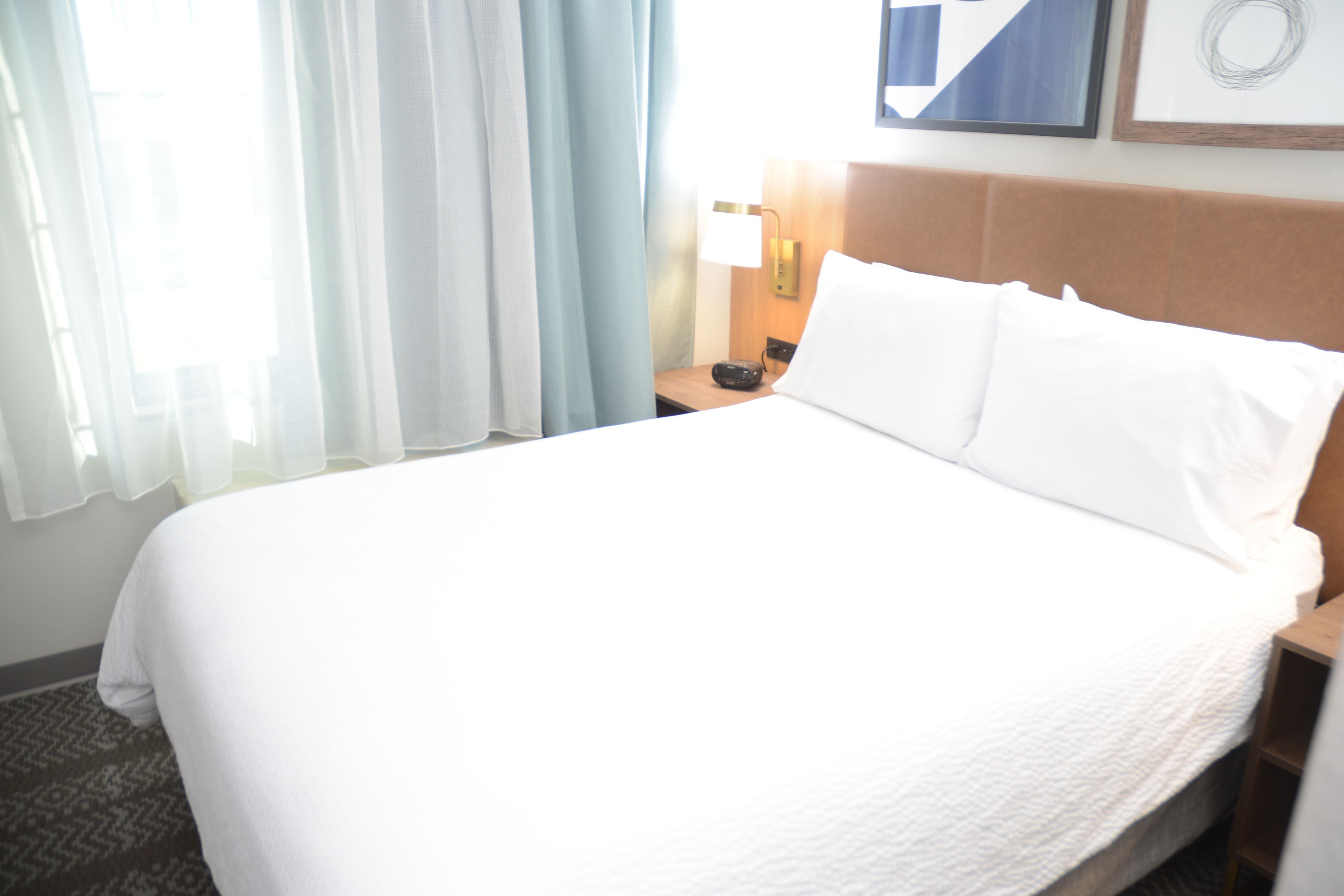 image Cozy sleeping area with a comfortable bed and natural light.