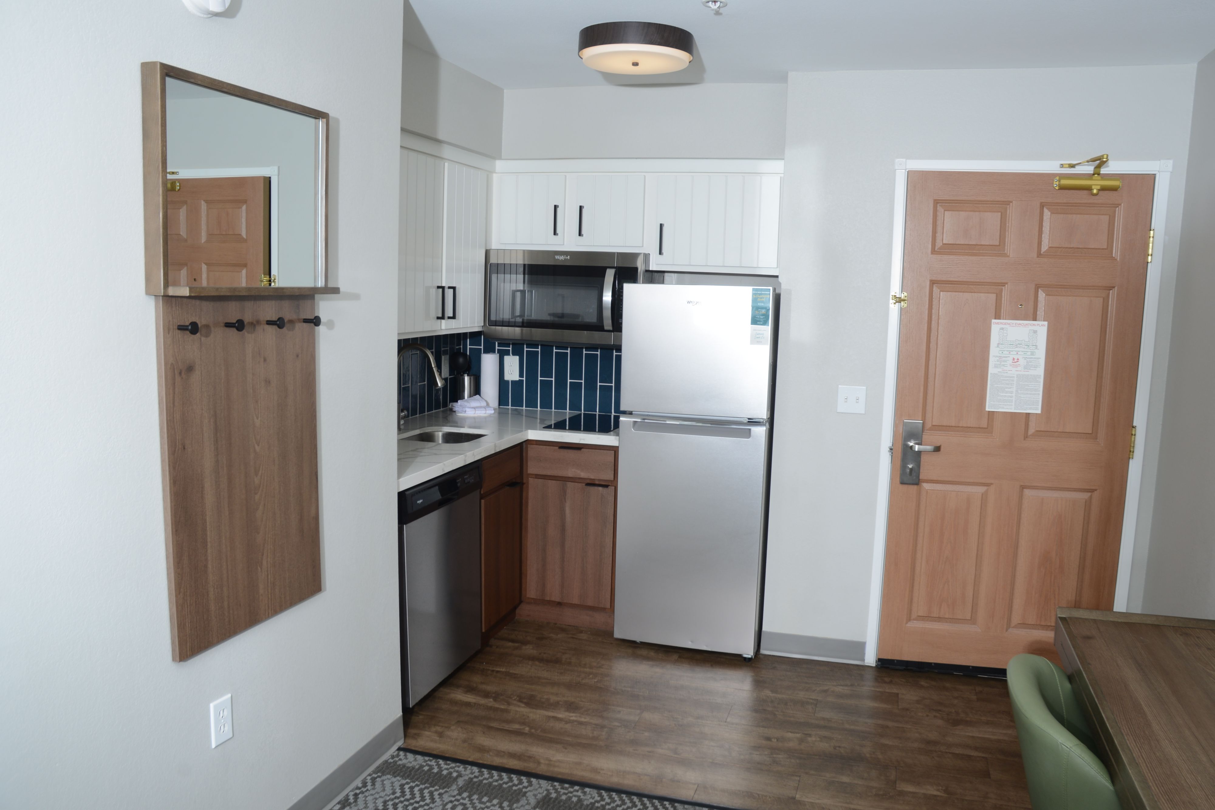 image Modern kitchen equipped with stainless steel appliances and cabinetry.