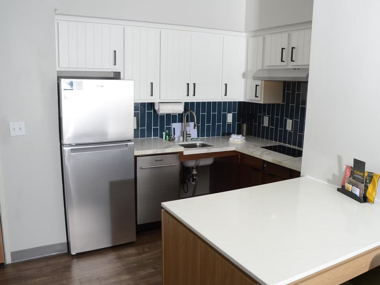 image Fully-equipped kitchen with sleek cabinetry perfect for in-room meals.