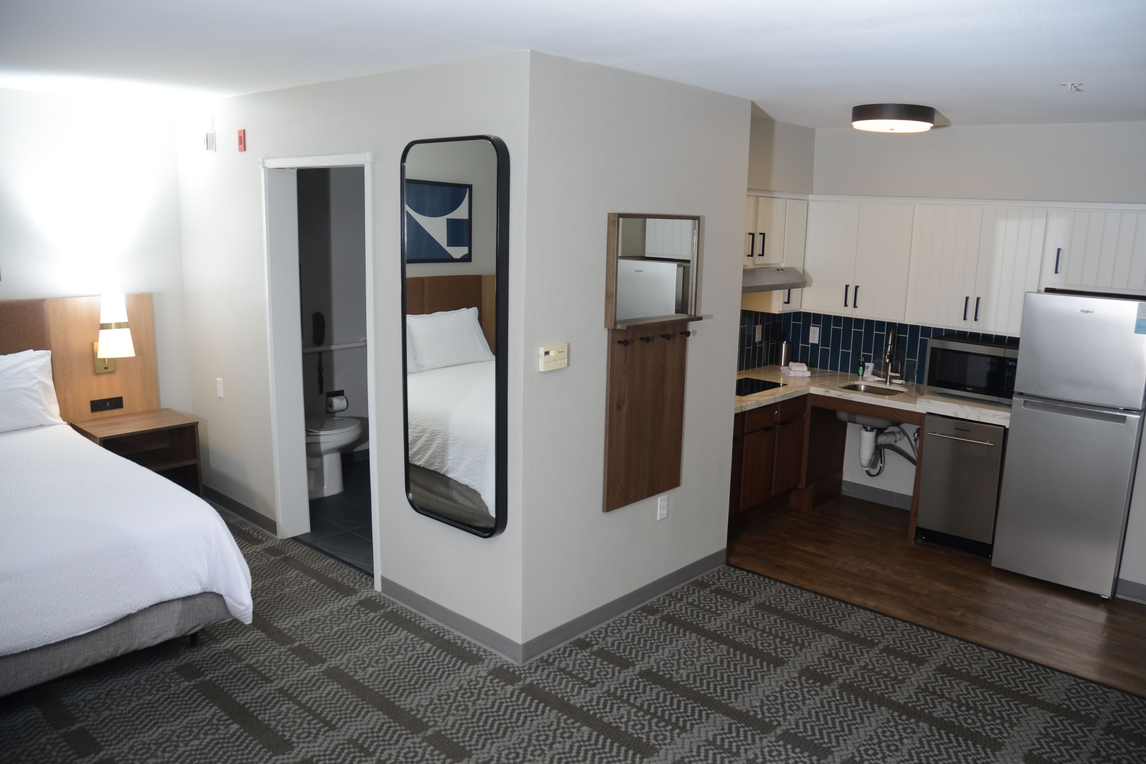 image Well-appointed suite bedroom with kitchenette and modern furnishings.