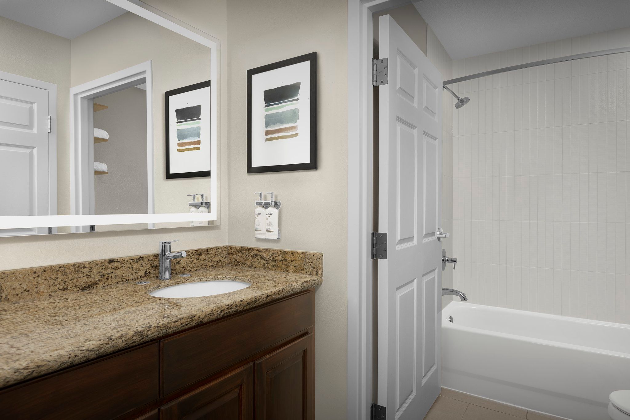image Freshen up in this bright bathroom featuring sleek finishes and complimentary toiletries.