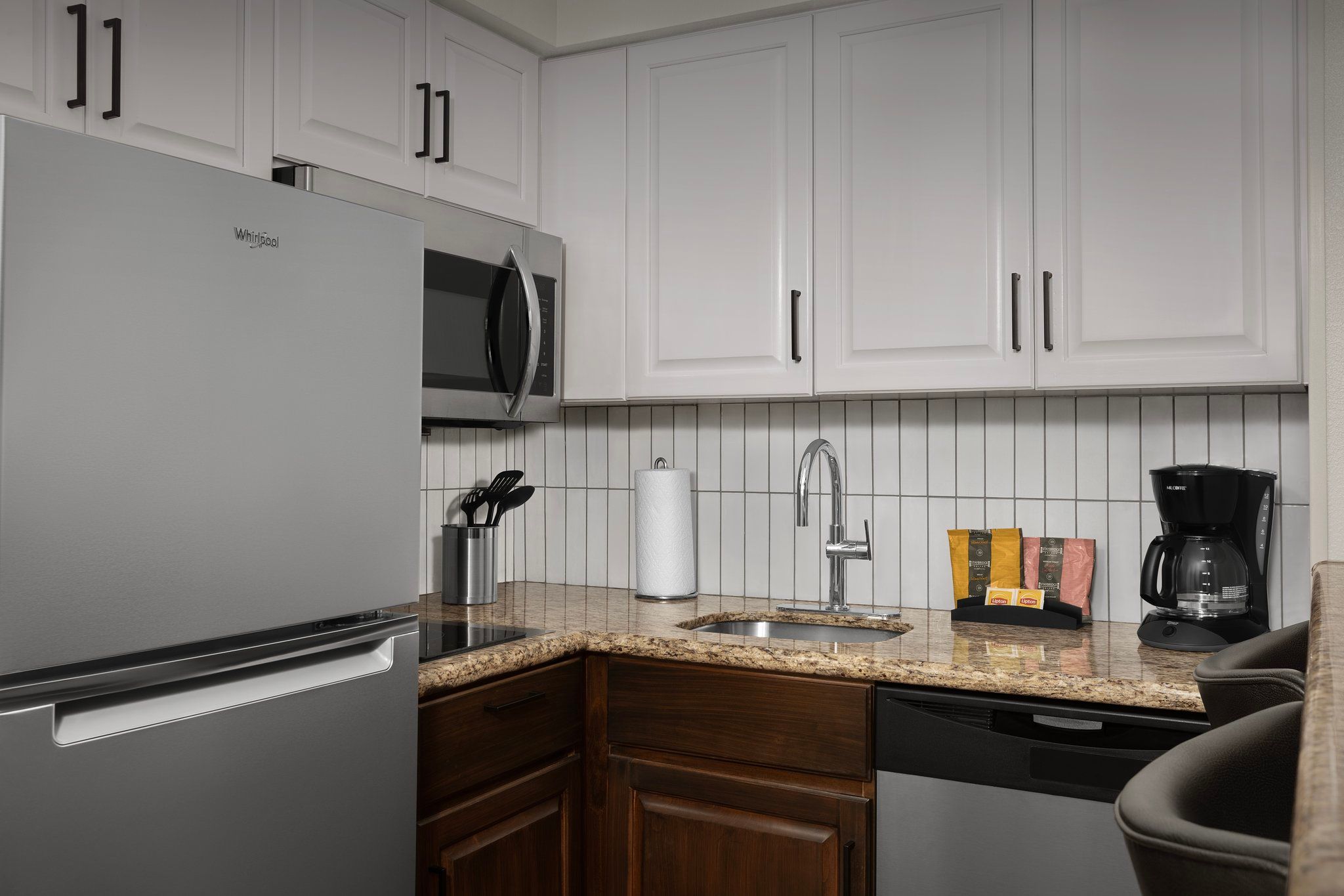 image Whip up a meal in this stylish kitchen, complete with modern appliances and countertop space.