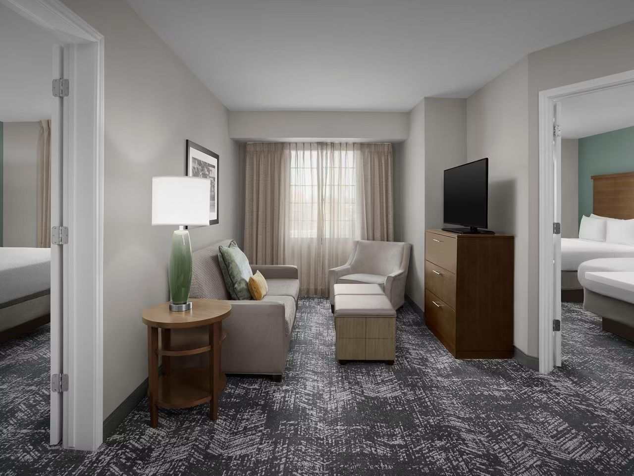image Spacious living area with adjacent bedrooms.