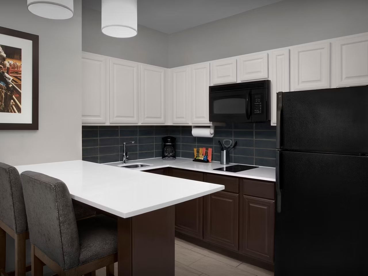 image Modern kitchen with bar seating and appliances.