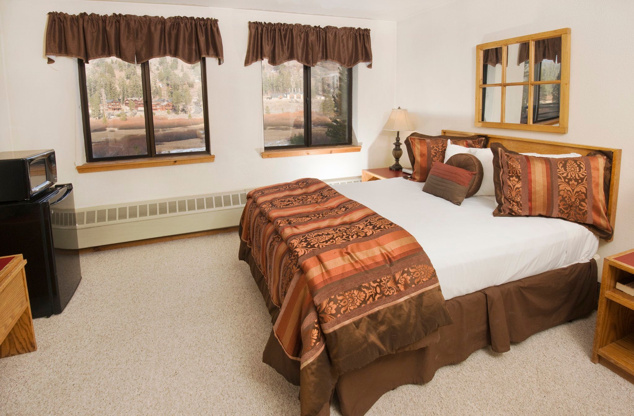 image Relax in a cozy room featuring a plush Queen bed, perfect for winding down after a day of adventures.