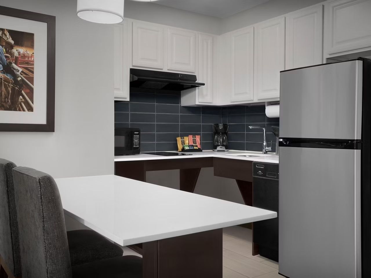 image Kitchen area with appliances and seating.