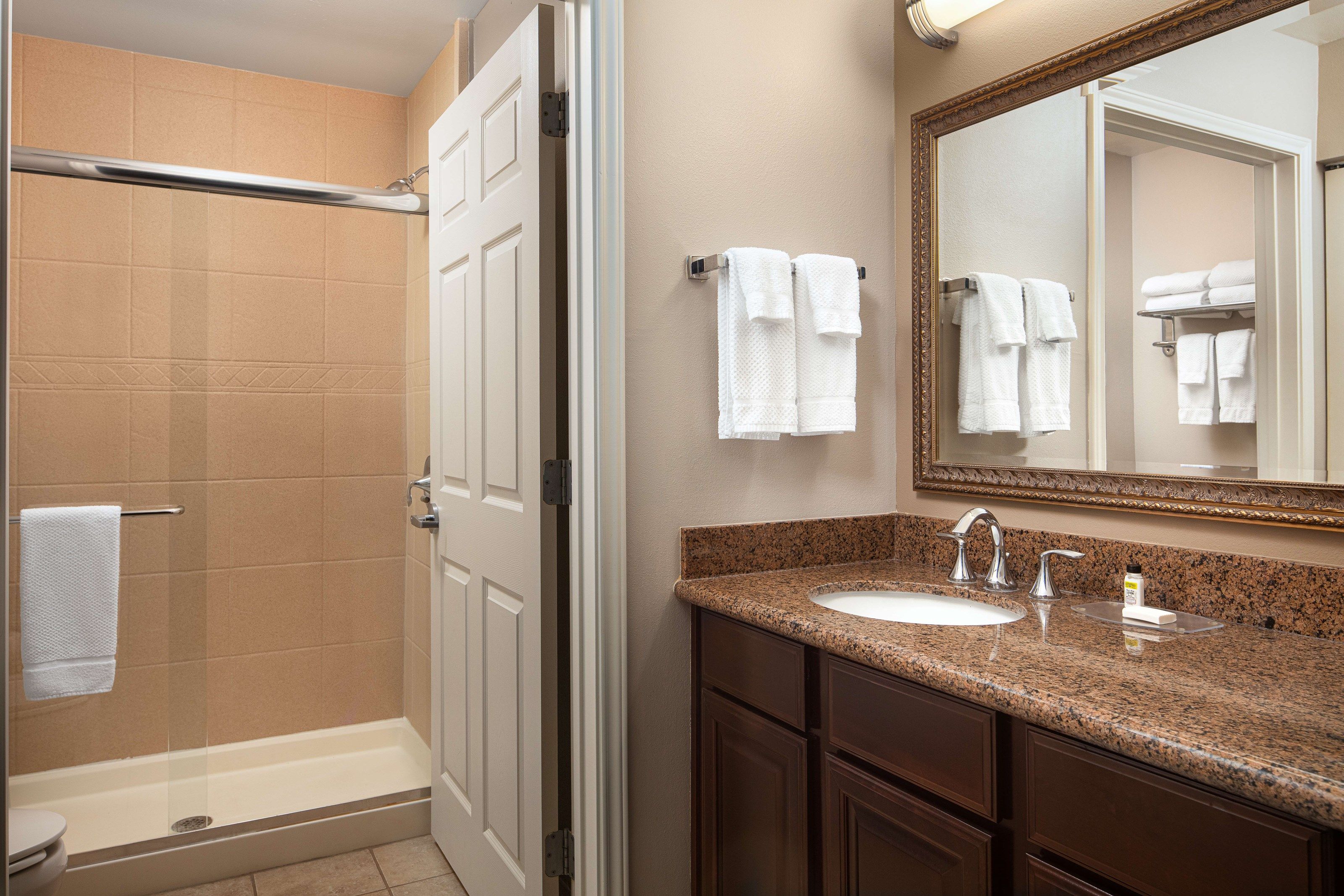 image Clean bathroom with a modern vanity and spacious shower.