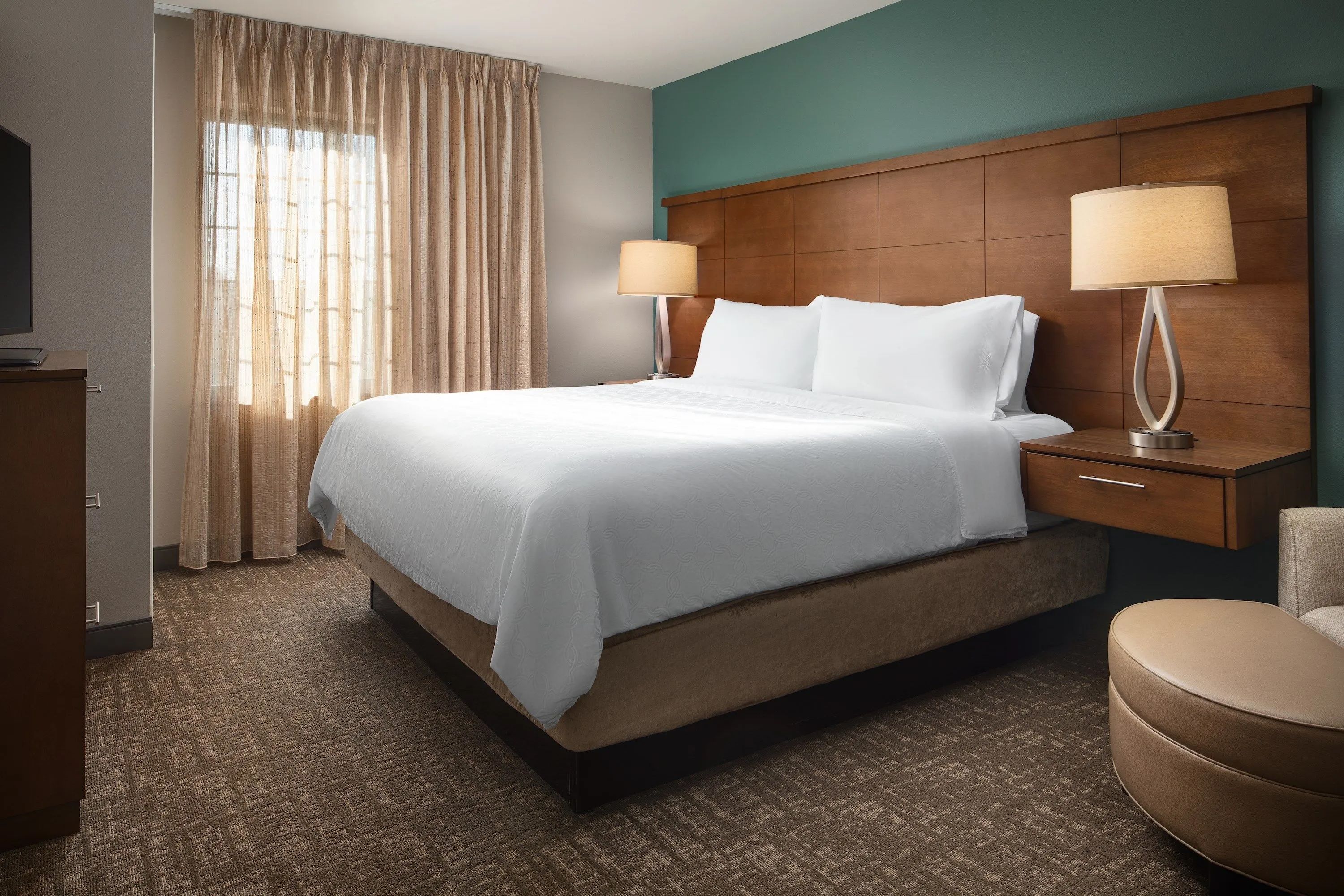 image Comfortable bedroom with queen bed and modern furnishings.