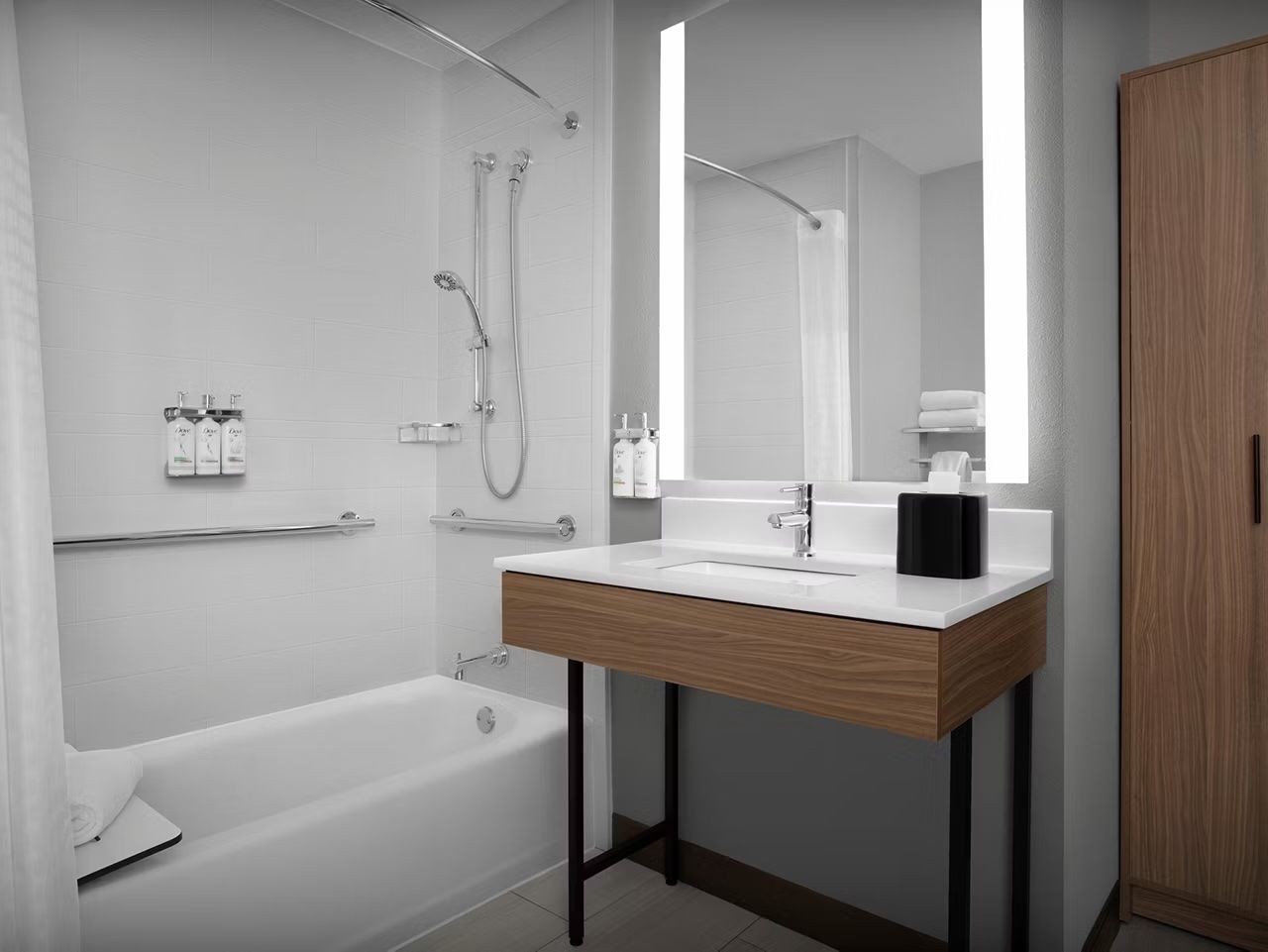 image Accessible bathroom with mobility-friendly tub and grab bars.