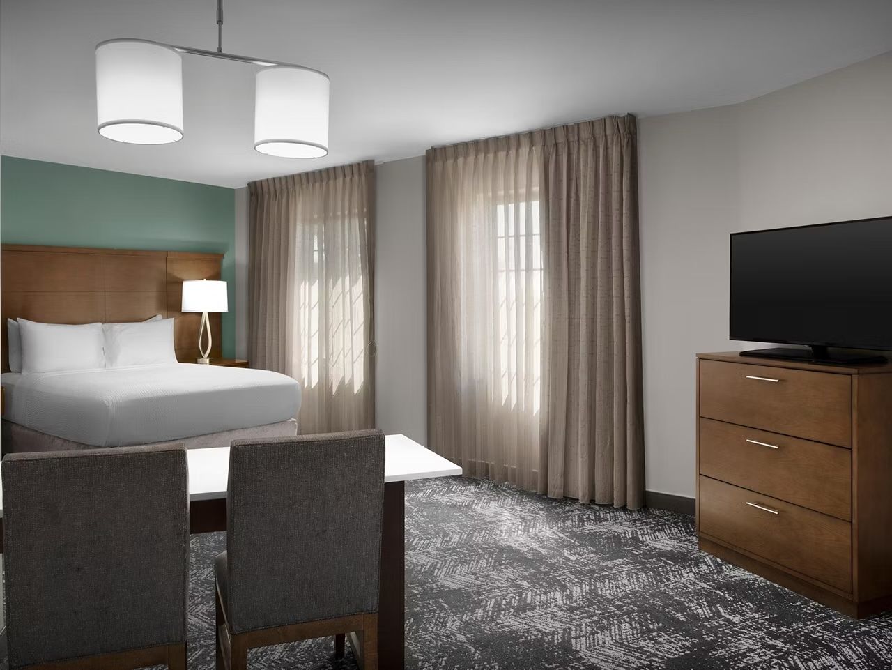 image Queen bed with fresh linens and modern furnishings.