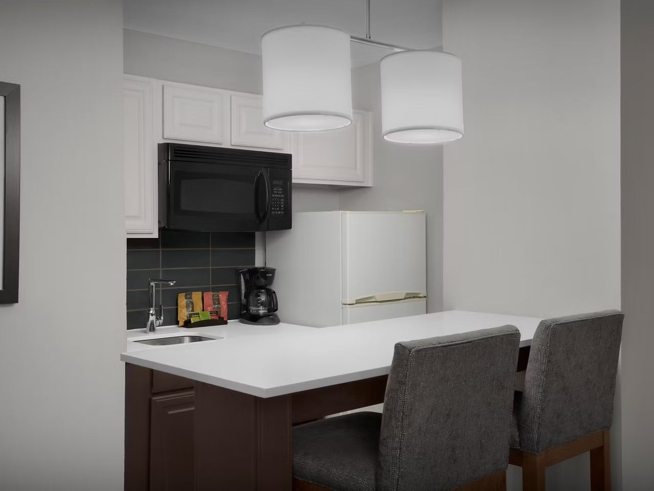 image Kitchen with modern appliances and seating area.