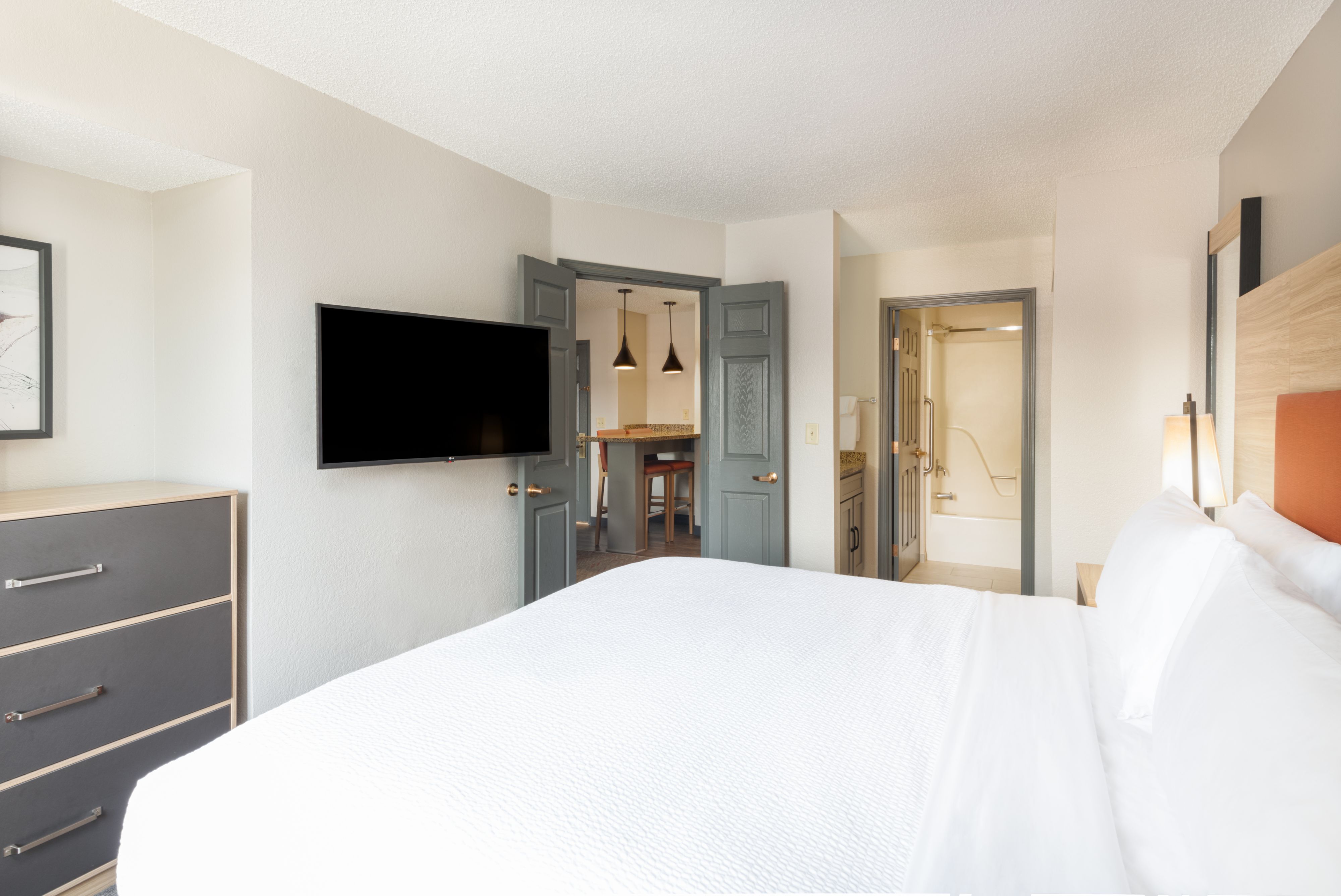 image Cozy bedroom with modern decor and flat-screen TV.
