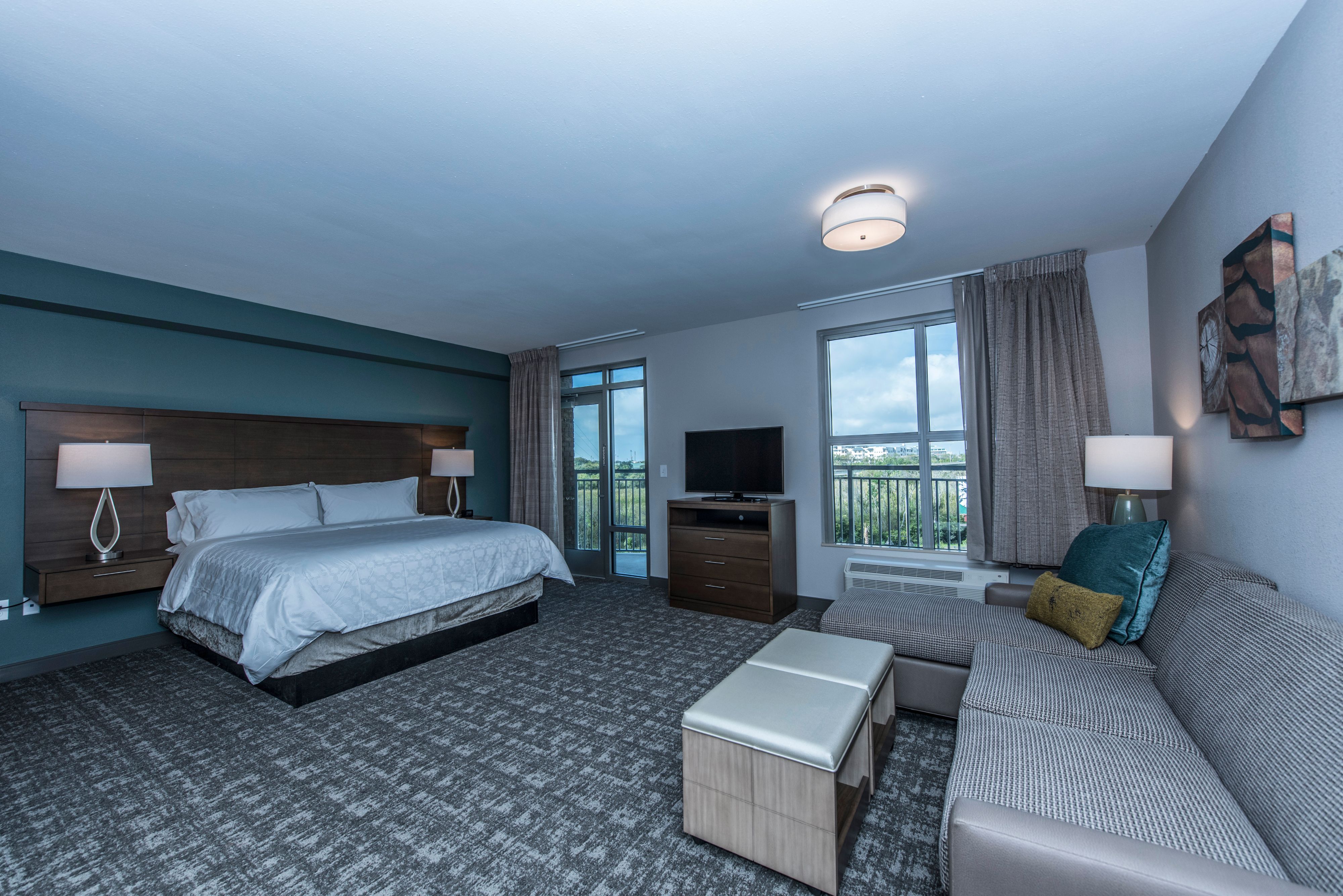 image Inviting bedroom with a king-sized bed and seating area by the window.