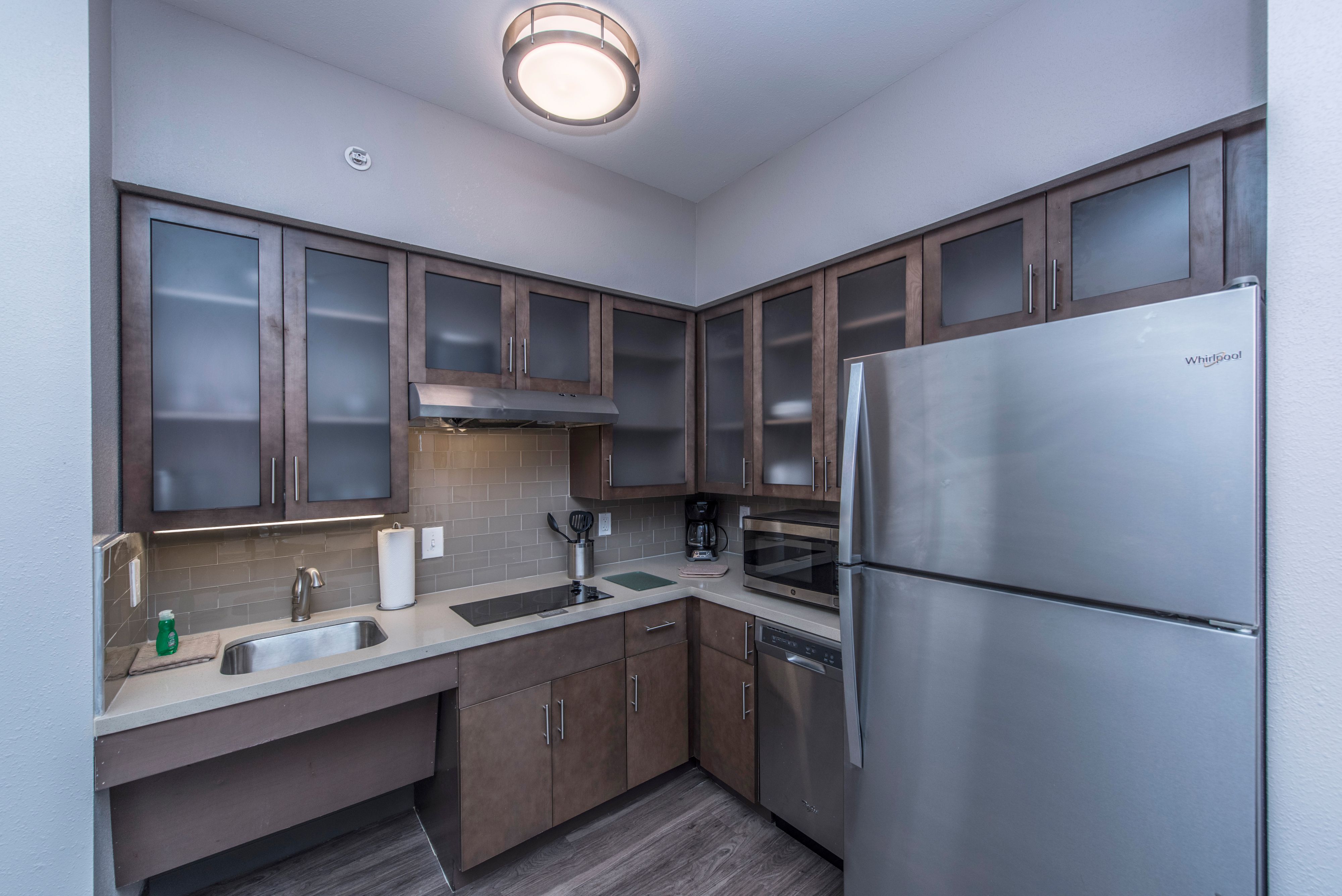 image Fully equipped kitchen with stainless steel appliances and ample storage.