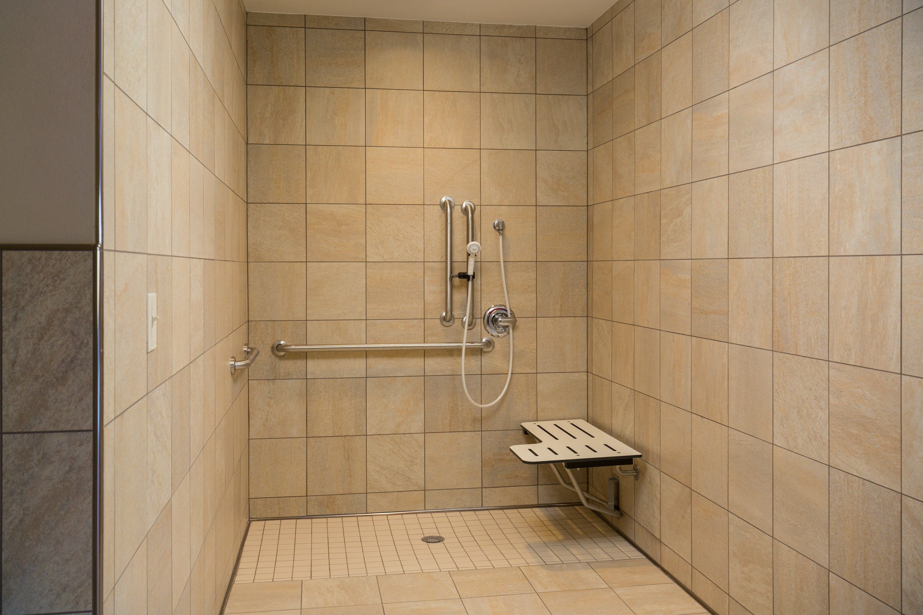 image Get ready for your day in the bathroom that features a roll-in shower.