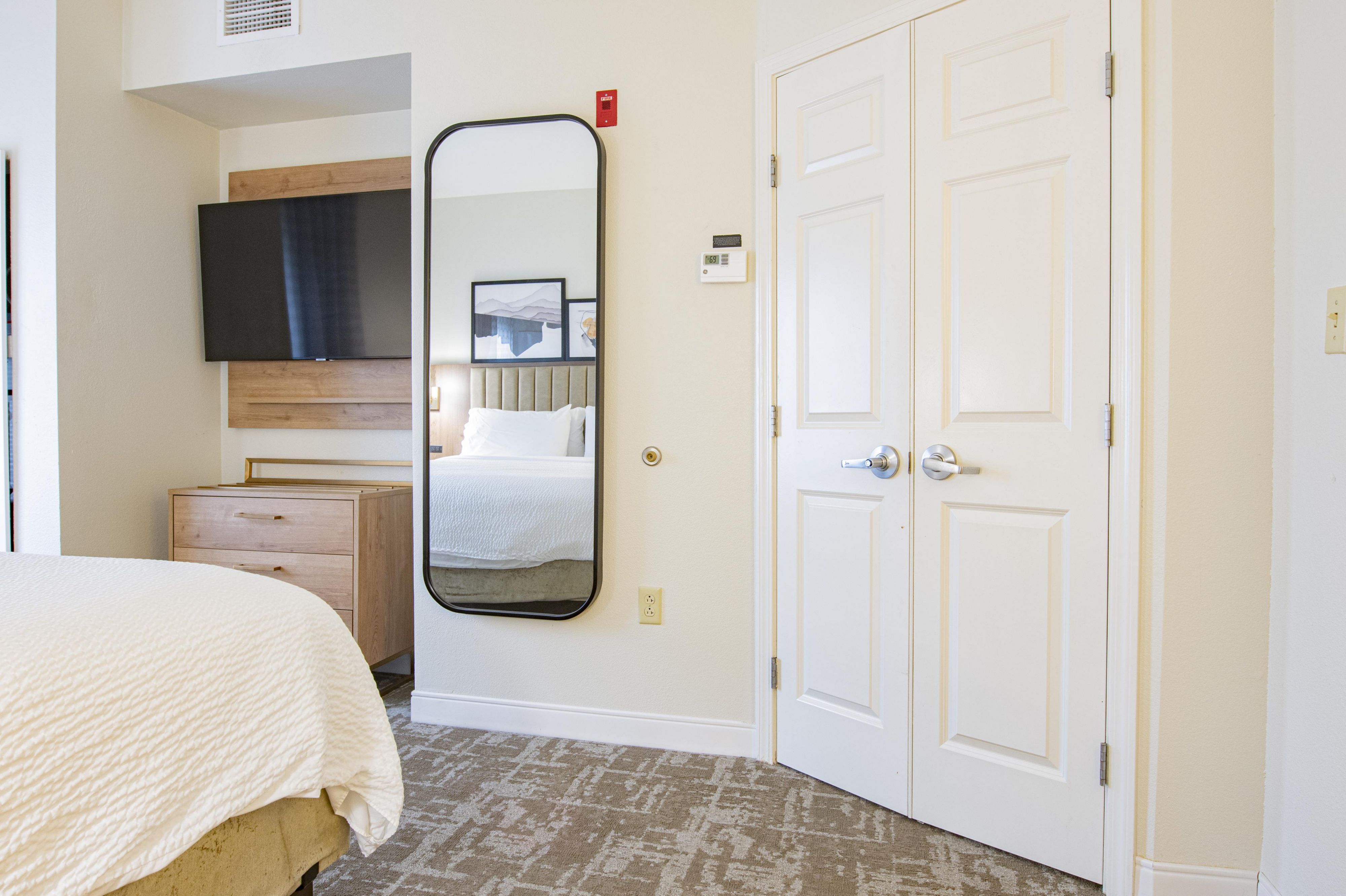 image Comfortable king bed with premium linens and wall-mounted TV.