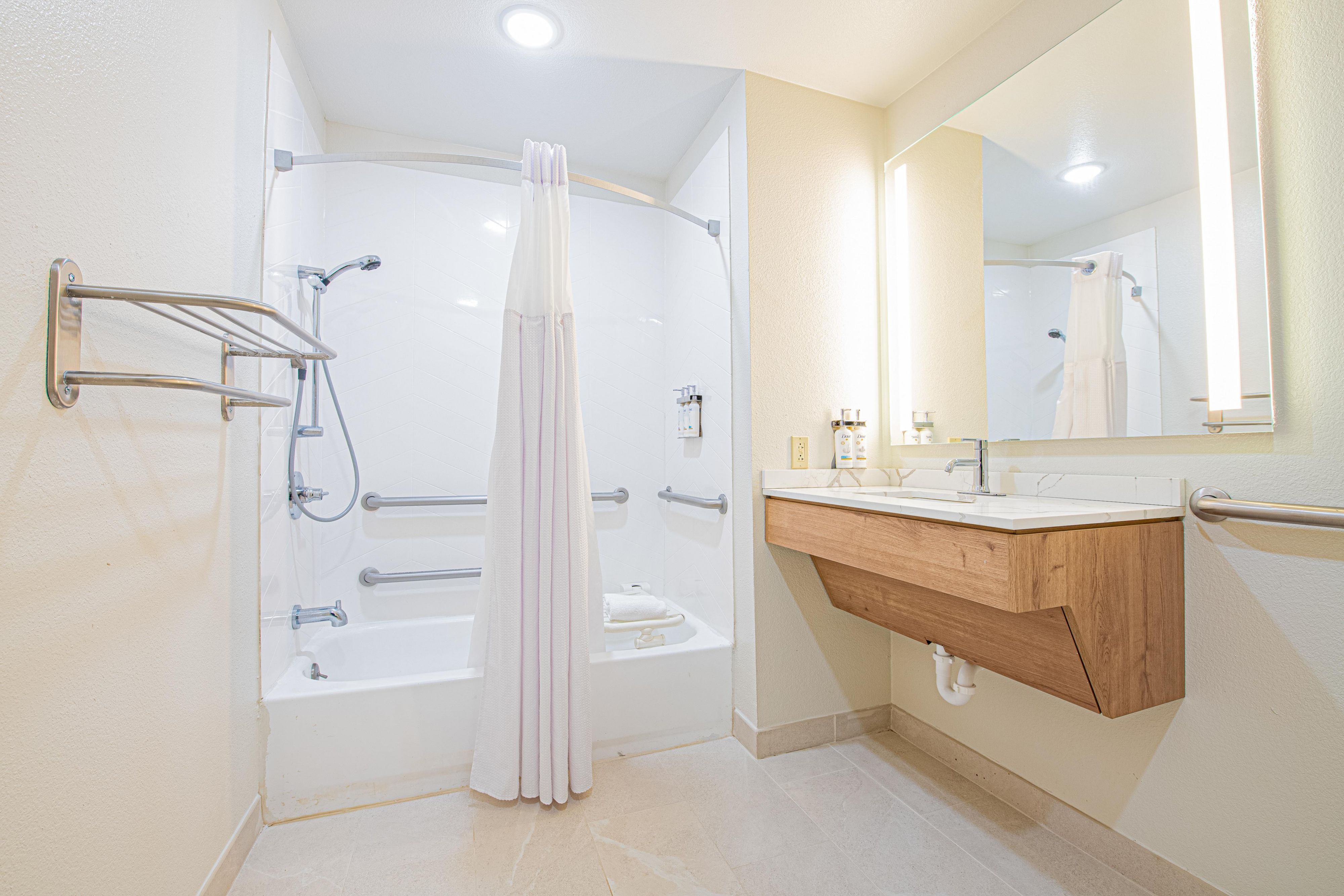 image Accessible bathroom with grab bars and modern fixtures.