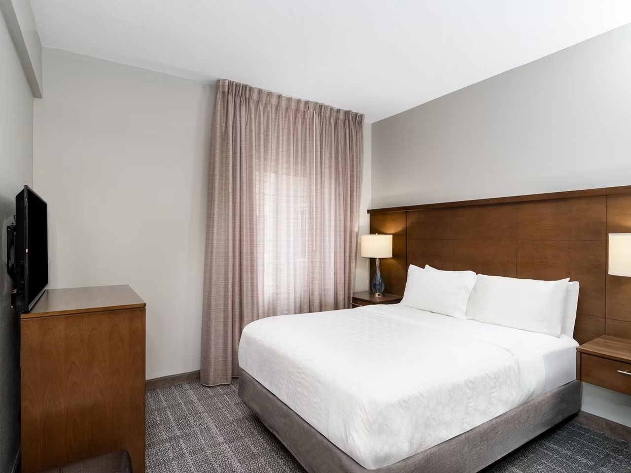 image Bedroom with king bed, nightstands, and television