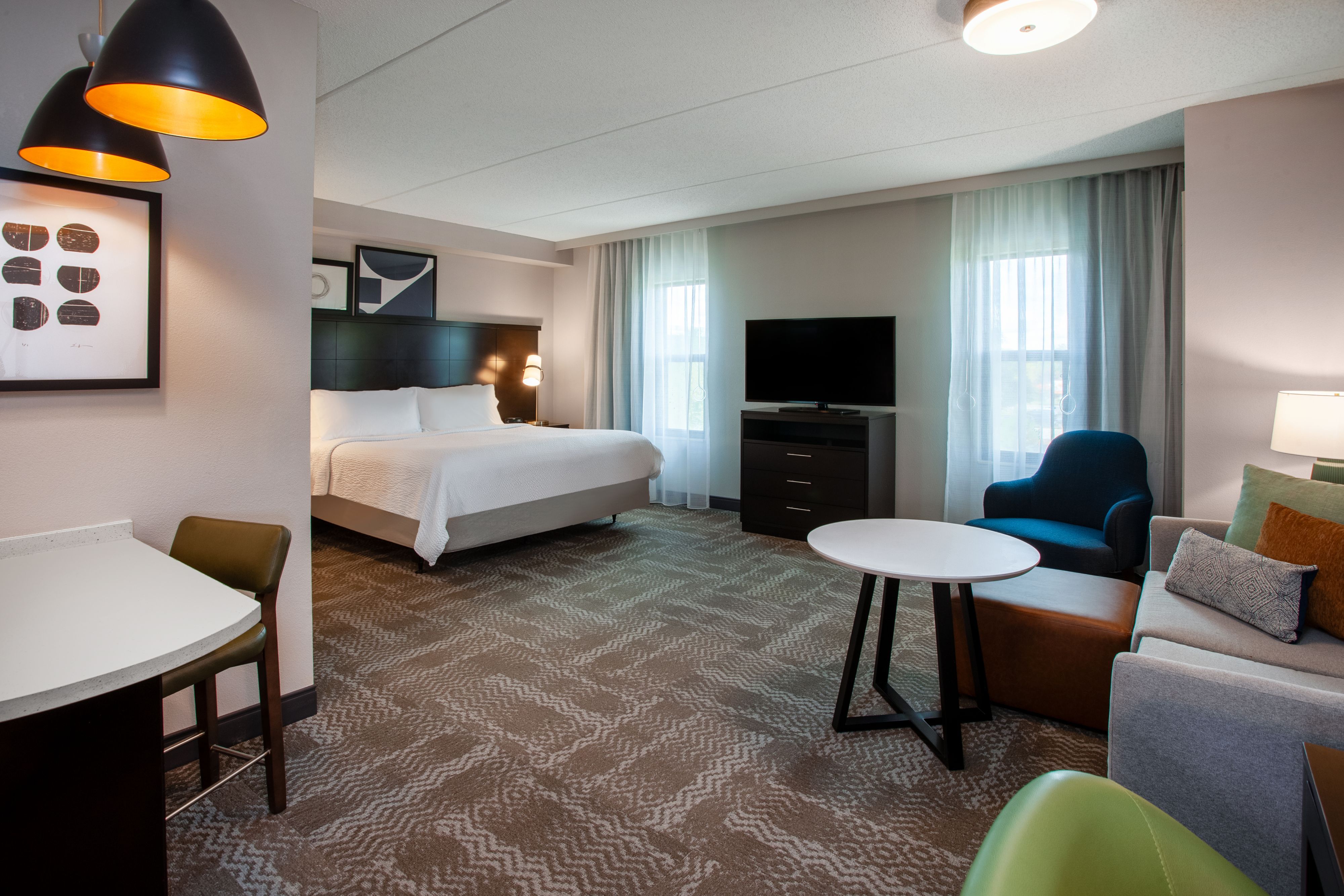 image Cozy suite with a king bed and comfortable seating area.