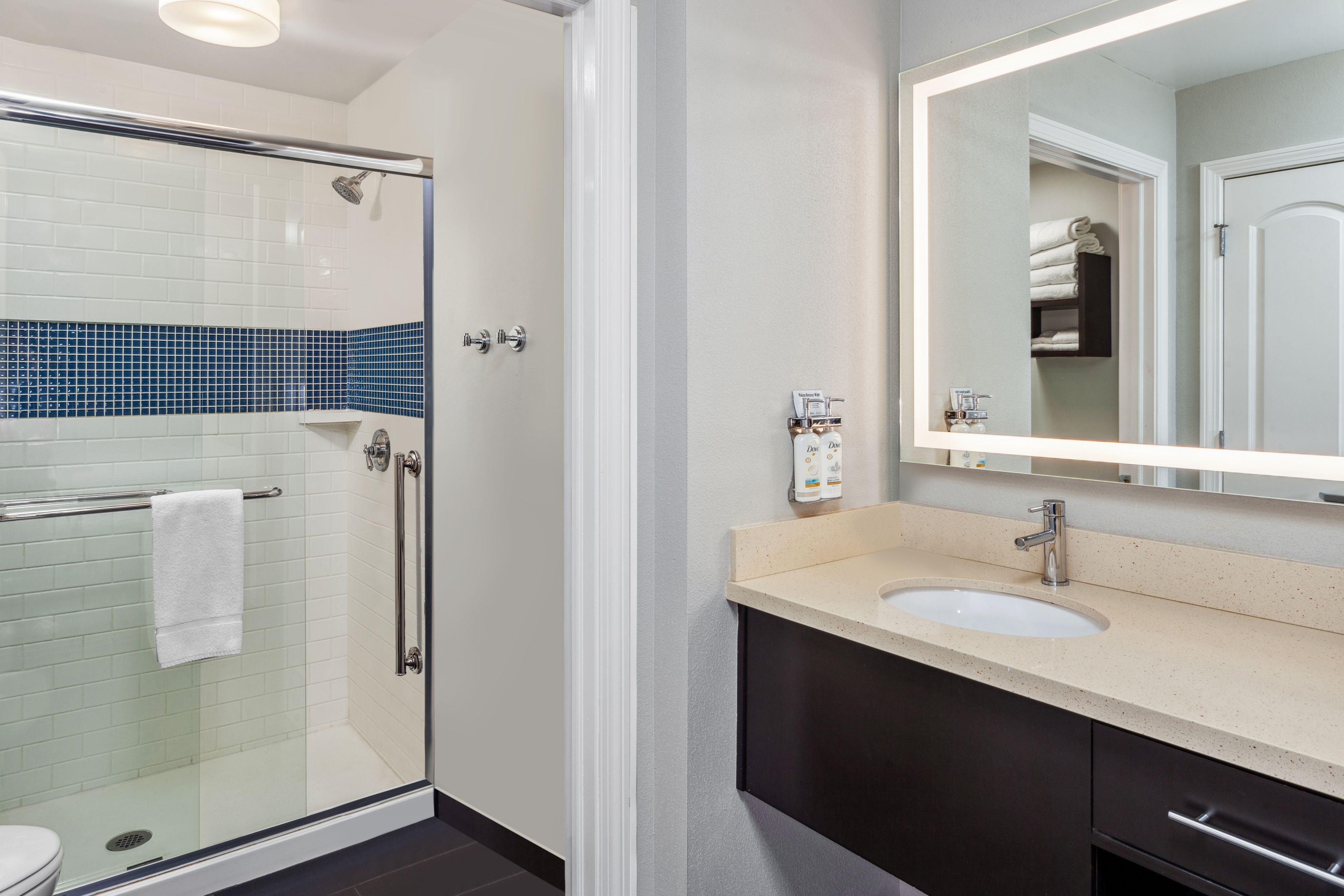 image Bright bathroom with a walk-in shower and modern fixtures.
