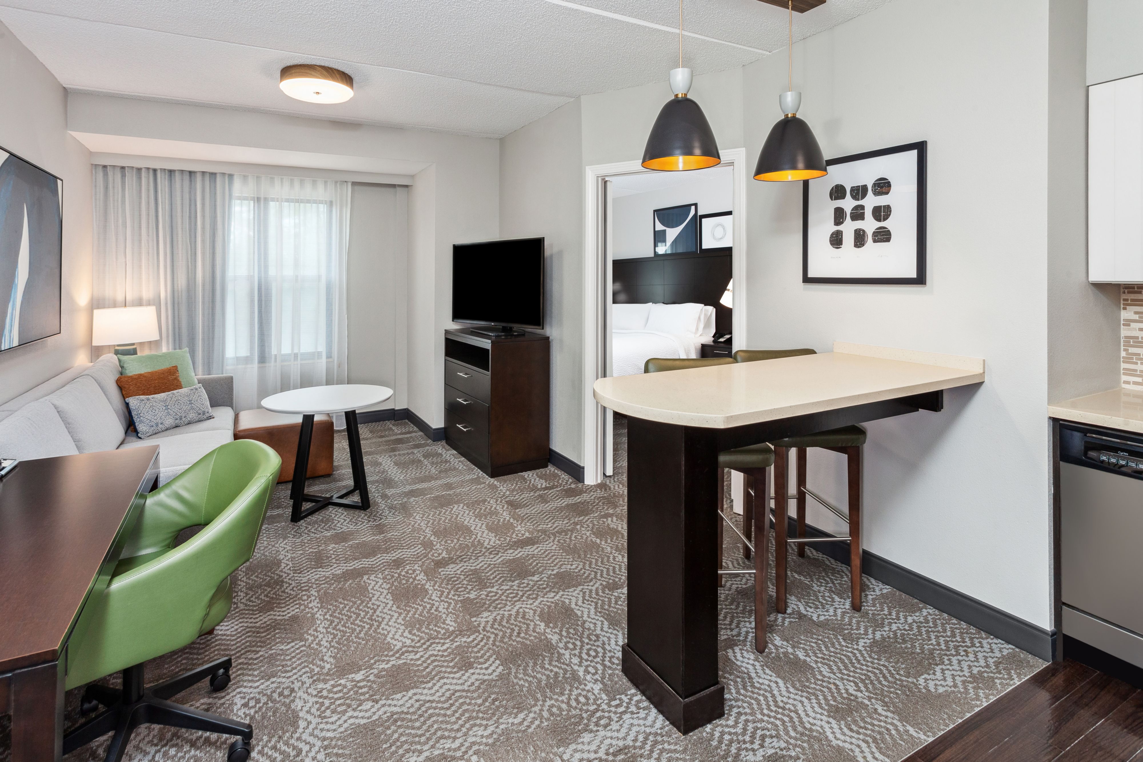image Open suite layout featuring a kitchenette and work desk.