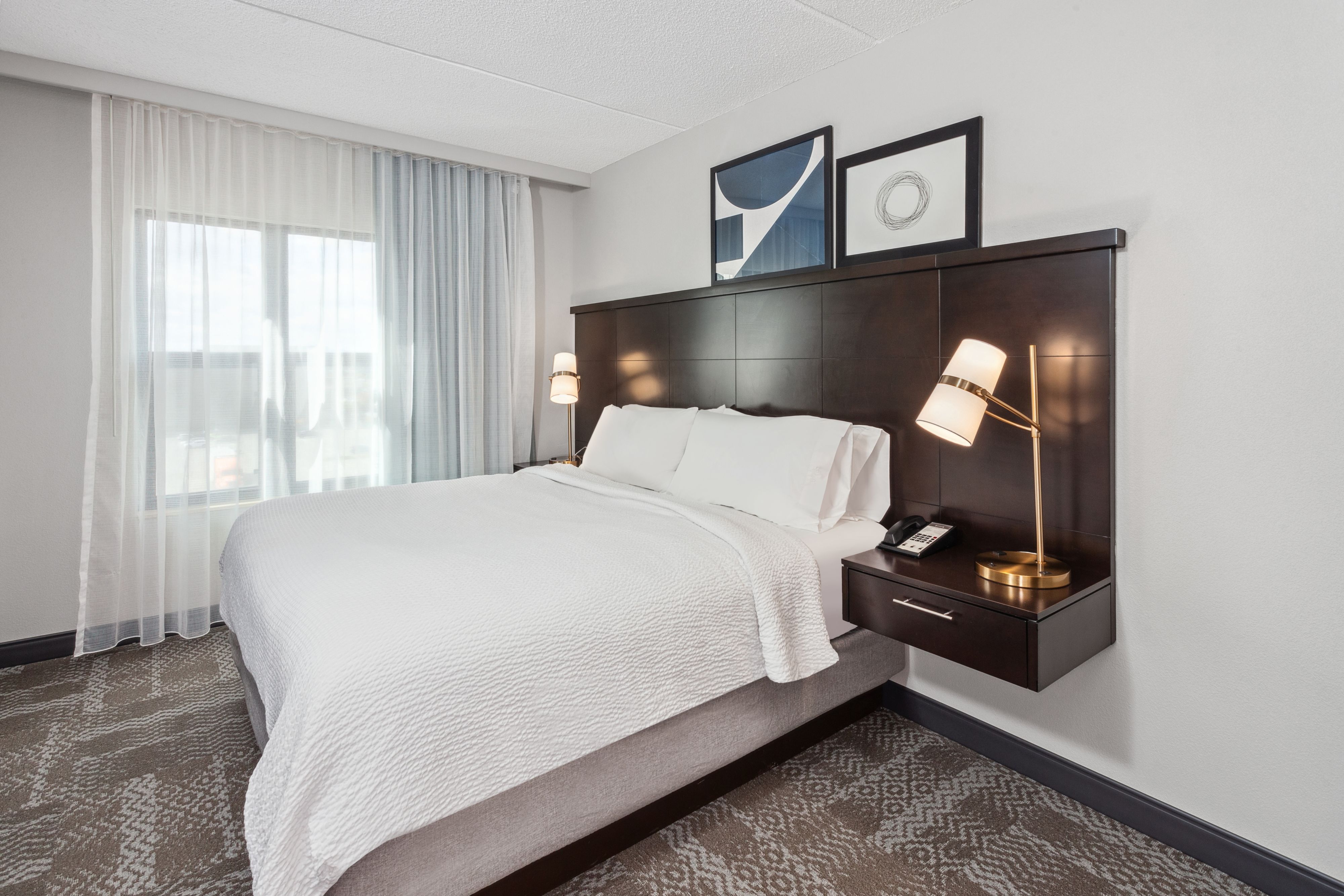 image Cozy bedroom featuring a king bed and modern decor.