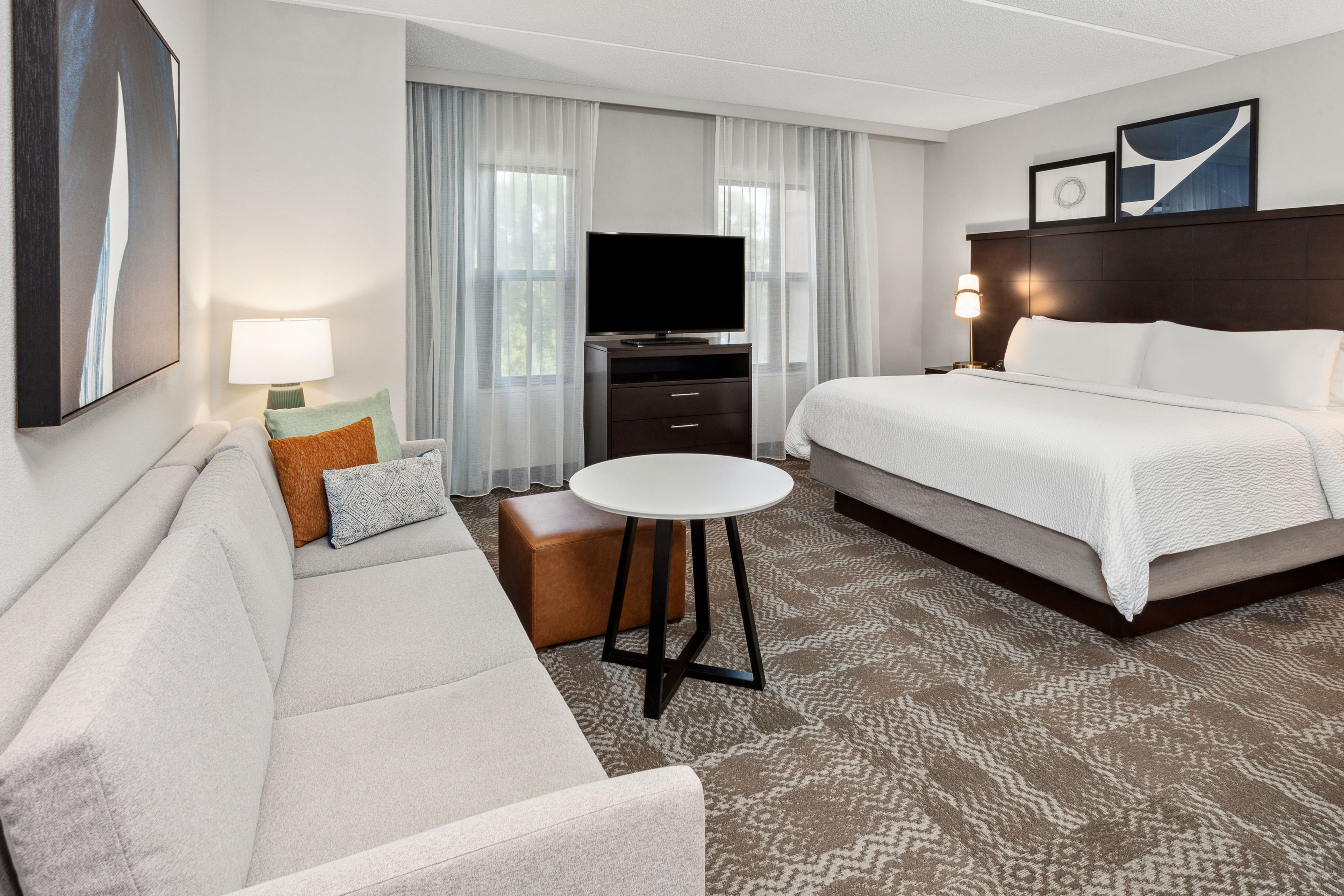 image Cozy suite features a plush bed and seating area.