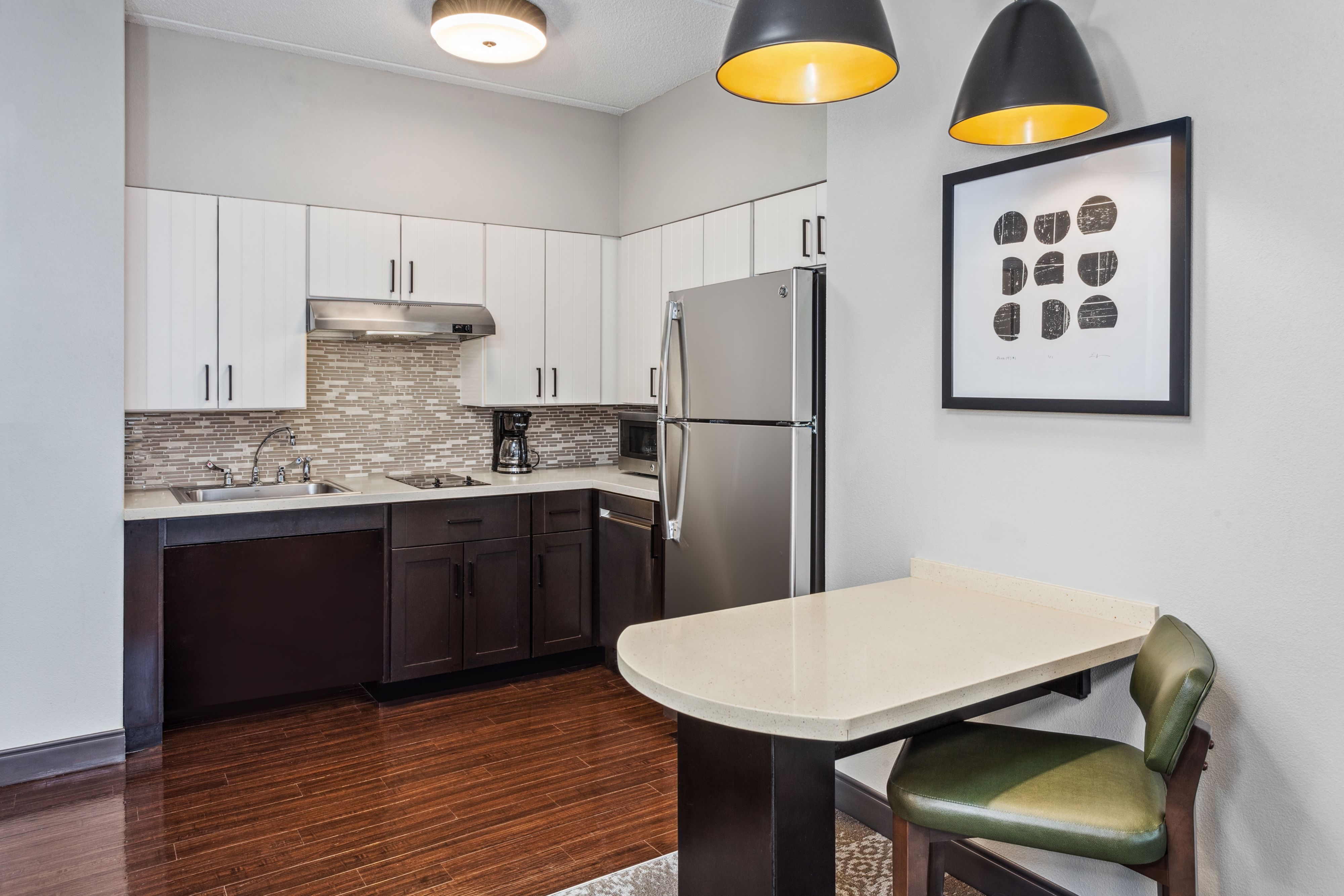 image Modern kitchen featuring sleek cabinetry and stainless appliances.