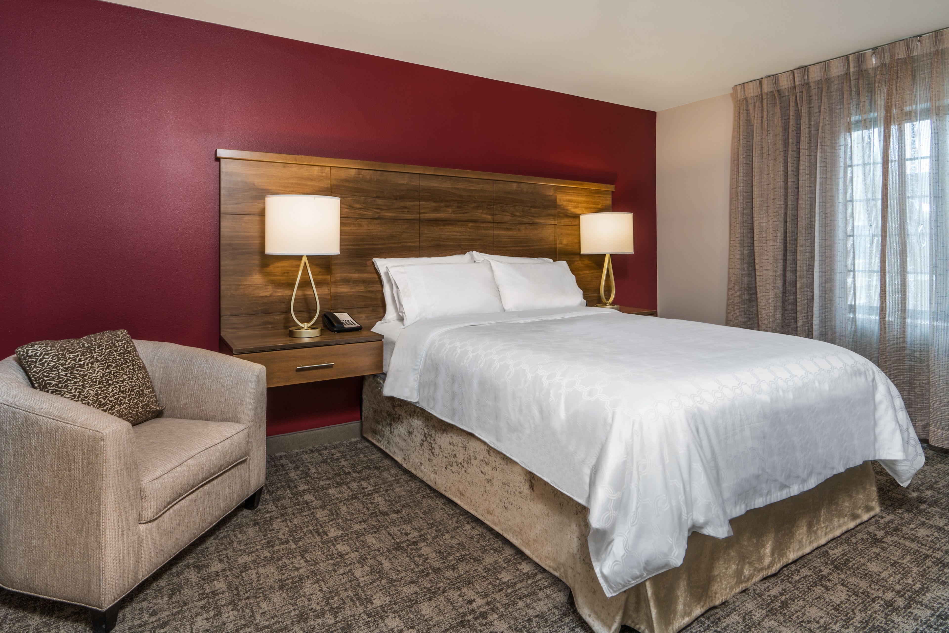 image Comfortable bedroom with king bed and bedside lighting.