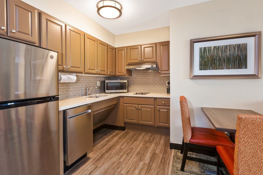 image Cook up a storm in the sleek kitchen, complete with modern appliances and a cozy dining nook