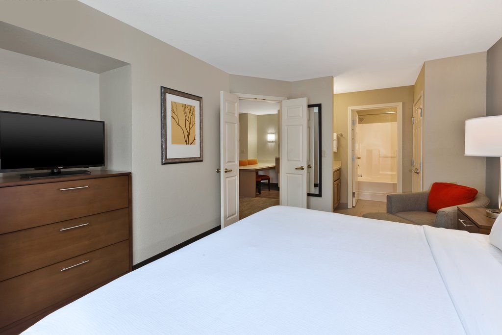 image Wake up in a spacious bedroom, complete with a plush king-sized bed for your comfort.