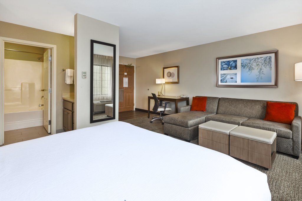 image Relax in your cozy retreat featuring a Queen bed and comfortable seating for unwinding after adventures.