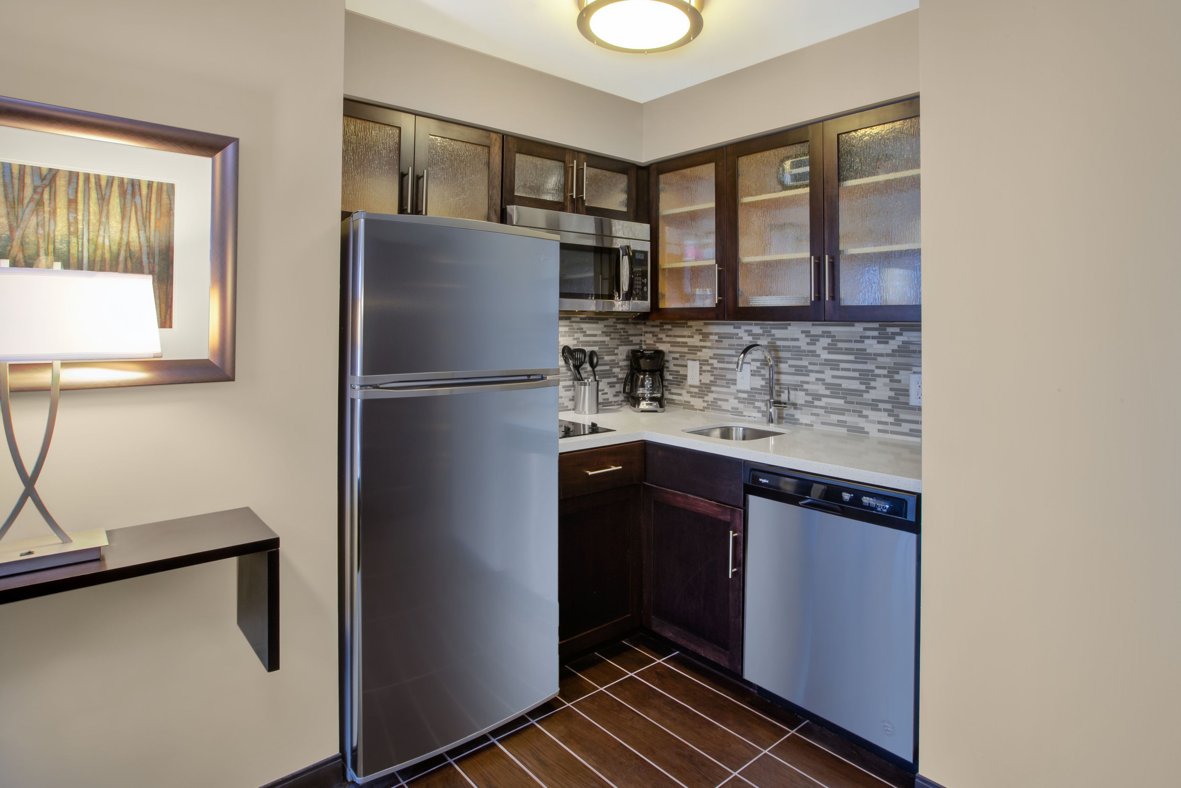 image Fully equipped kitchen with stainless steel appliances and counter space.