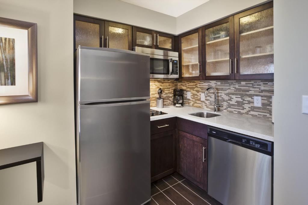 image The kitchen features a full sized fridge and freezer and an oven