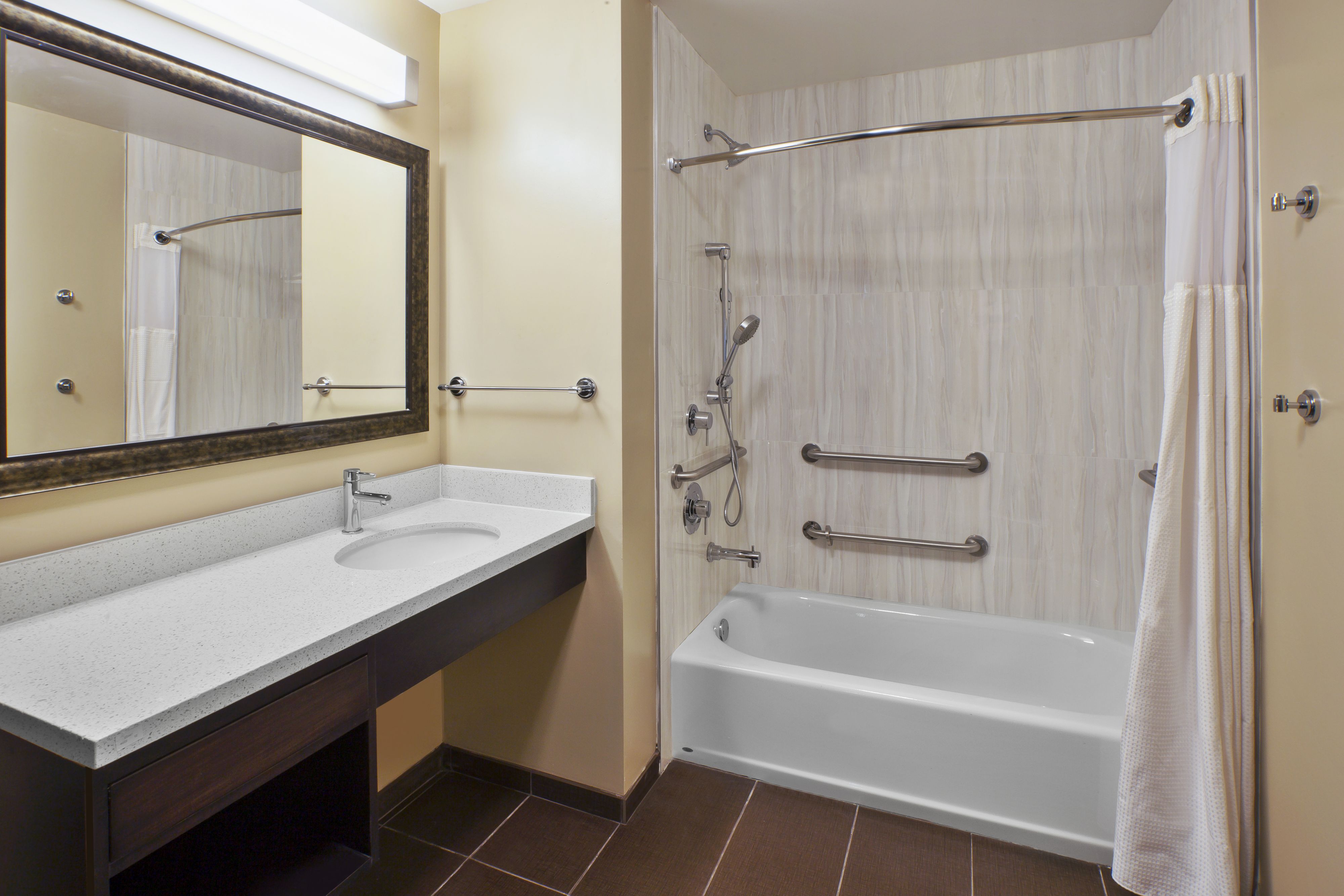 image Accessible bathroom with tub and modern shower fixtures