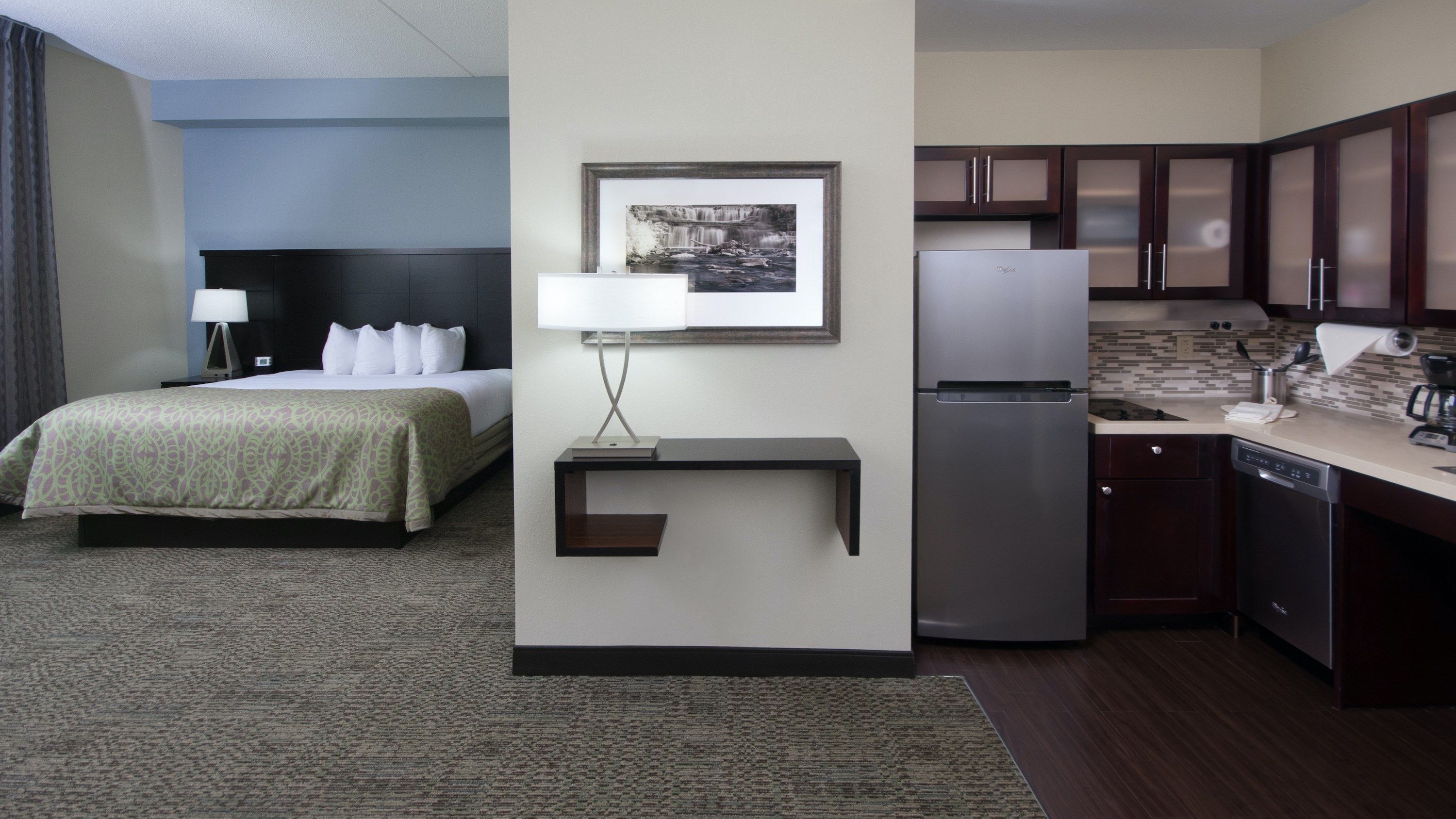 image King bed with white linens and a wide, open layout built for easy wheelchair access throughout