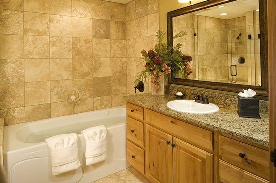 image The bathroom features a vanity mirror, shower and bathtub