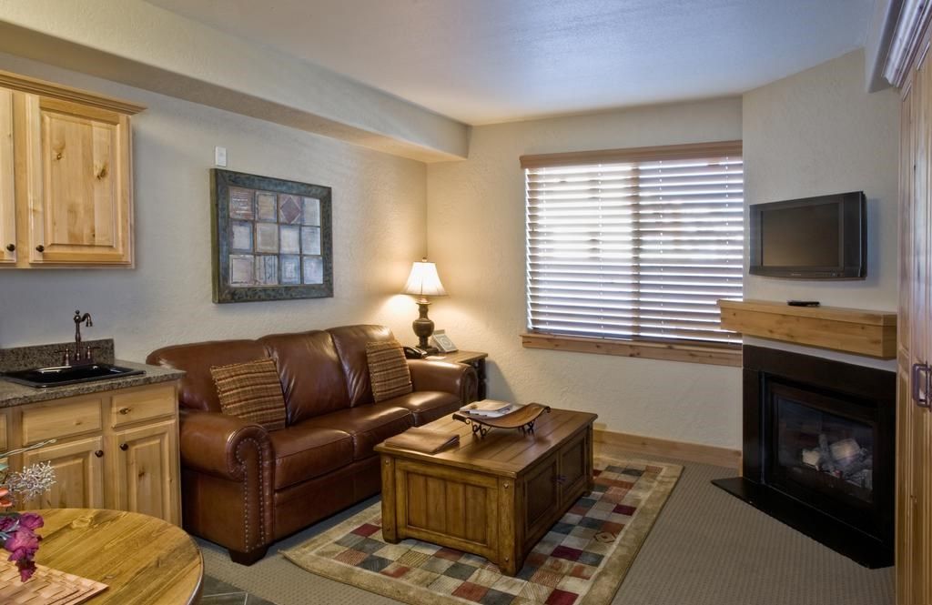 image Relax in the cozy living area, complete with fireplace and TV