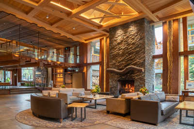 Experience the grandeur of our open-concept great room with a towering stone fireplace and floor-to-ceiling windows.