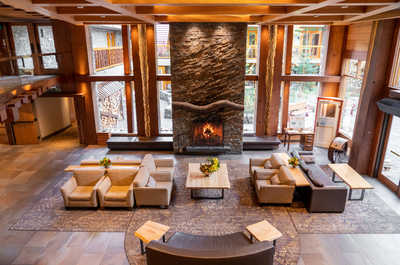 Relax in our spacious living room, where a stone fireplace meets stunning views.