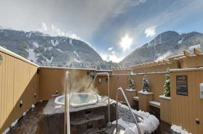 Soak in the hot tub surrounded by spectacular mountain views