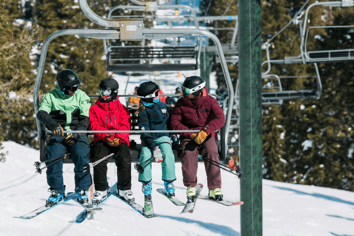 image Share smiles and stories with friends as you ride the lift, with the mountain's beauty unfolding around you.