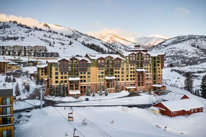 image Set against a breathtaking snowy backdrop, the Grand Summit Hotel captivates with its elegant architecture and convenient access to winter sports, ensuring a memorable stay in the heart of Park City's ski paradise.