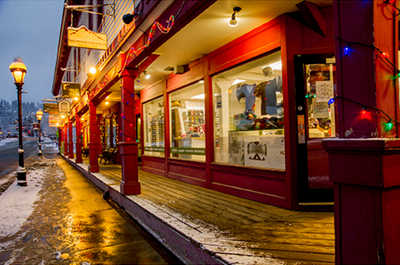 The warm lights of winter illuminate a snowy Ski Hill Road.